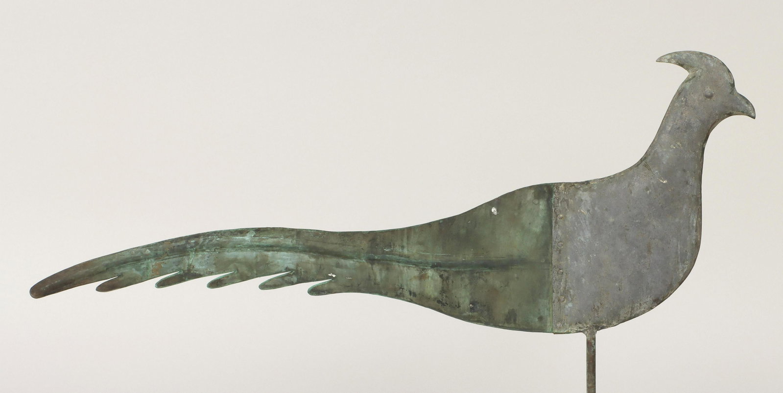 American folk art pheasant weathervane: American folk art pheasant weathervane, having flat molded or repousse copper tail and hollow-bodied molded tin head, 20th century. Seam split, wear and accretion from use. 29-1/2''l. Provenance: Esta