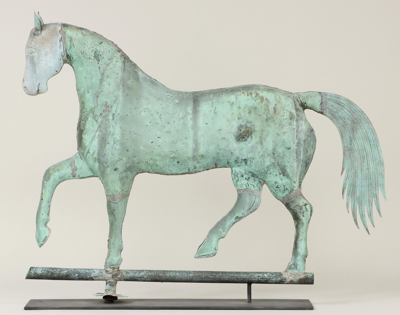 A. L. Jewell & Co. horse weathervane: A. L. Jewell & Co. full-bodied prancing horse molded-copper weathervane, having cast zinc head with copper ears and flat copper tail. Some seam splits, repairs, minor losses. 27-1/2''h, 2-3/4''w, 34''