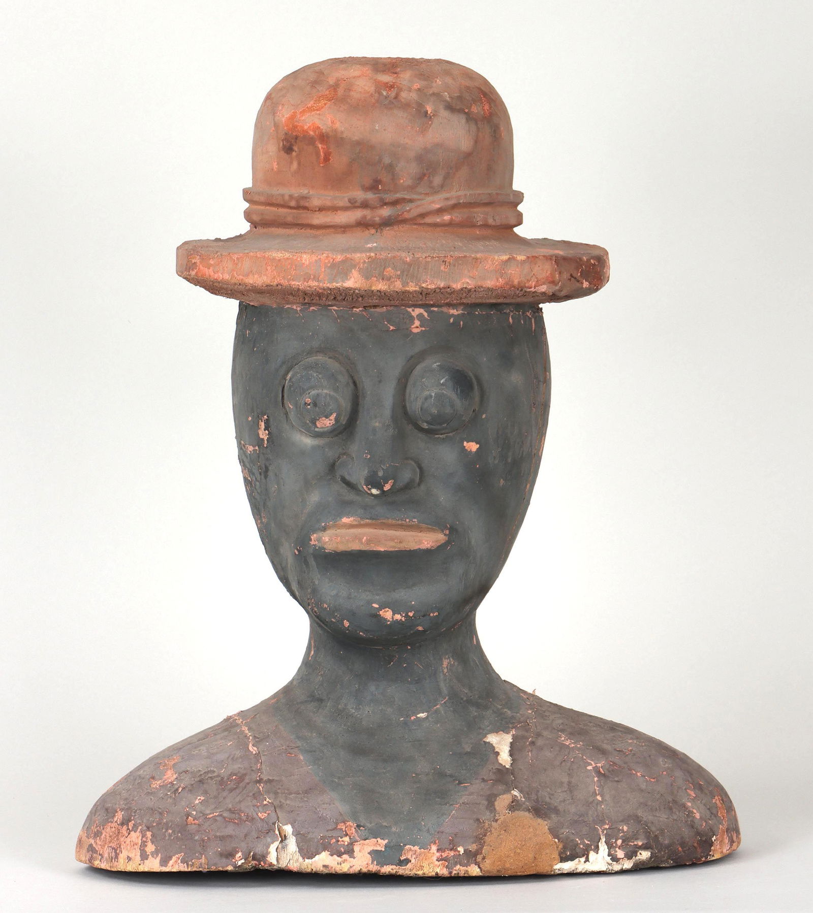 Large Black Americana folk art bust of man: Large Black Americana folk art carved, gessoed and painted bust of man in hat. Some paint and gesso loss. 20''h, 16-1/2''w, 9-1/2''d. Provenance: Estate of Joseph ''Jay'' St. Mark, PhD, of Newtown, Co