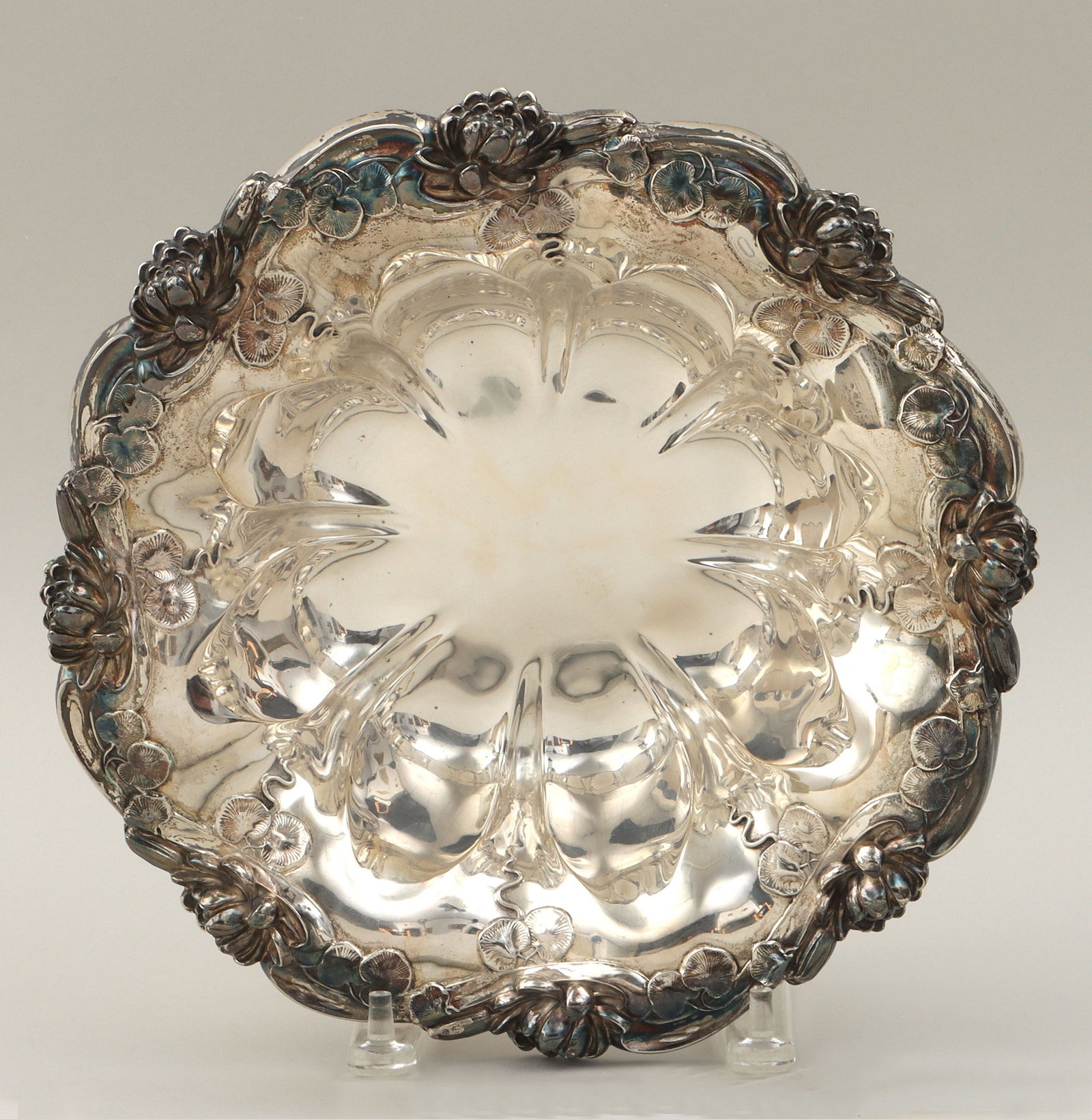 Sterling bowl, Simons Brothers, PA: American sterling silver bowl, Simons Brothers, Philadelphia, PA, having lobed sides and rim with water lilies in relief, marked on bottom. Minor scratches. 2-3/4''h, 11''dia; approximate weight 21.0