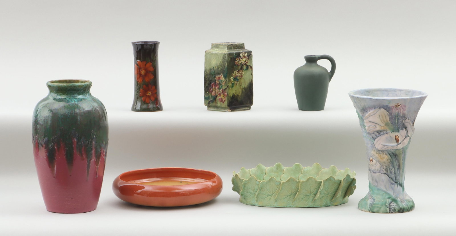Group of (7) American pottery: Group of (7) American pottery vessels, to include: large Fulper vase, (chips, minor scratches); T.J. Wheatley vase of diamond form with floral design, 1880, (chips at edges, crazing); Van Briggle jug 