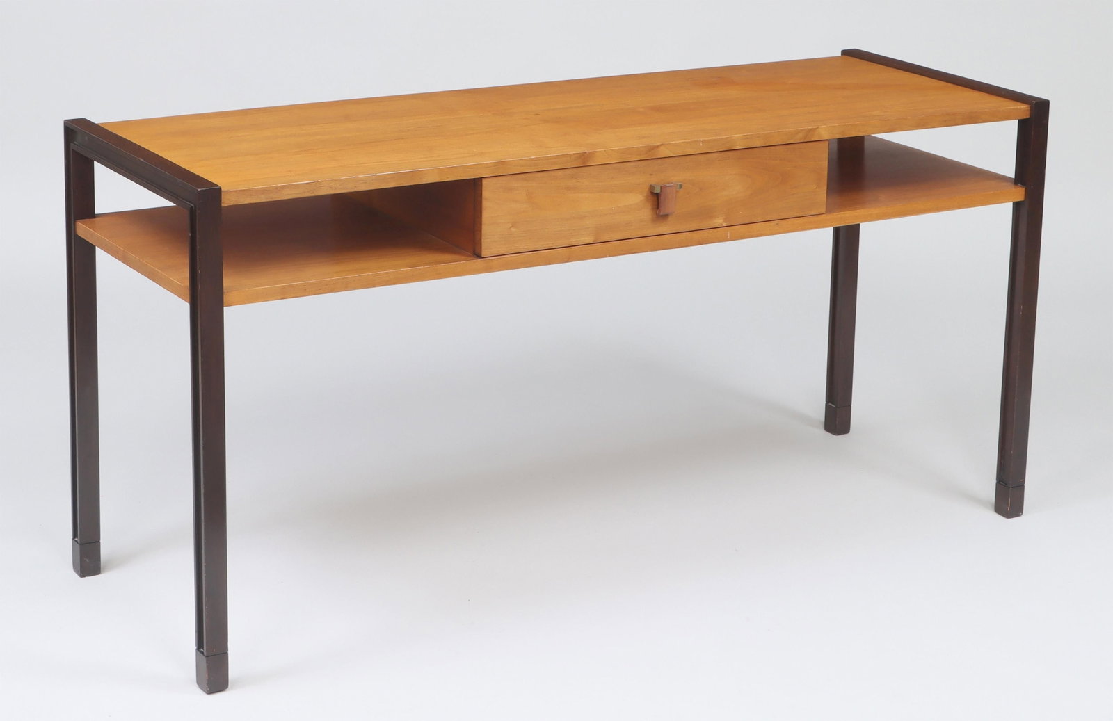 EDWARD WORMLEY (American, 1907-1995): EDWARD WORMLEY (American, 1907-1995), for Dunbar, console table with single drawer, walnut and ebonized mahogany, drawer with applied gold ''D'' manufacturer's label, ''Dunbar Berne Indiana''. Wear fr