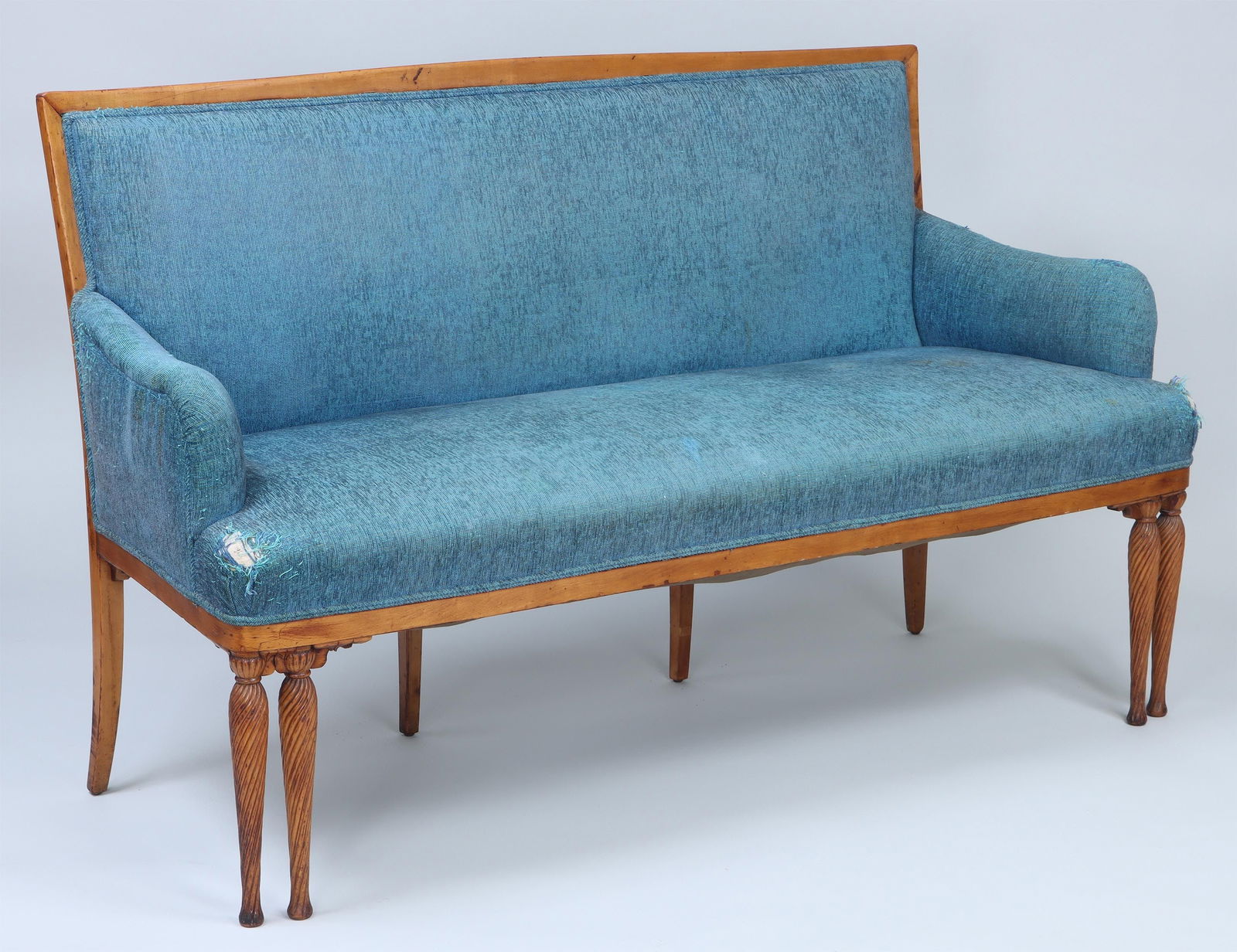 Louis Comfort Tiffany & Co., Associated Artists: Louis Comfort Tiffany & Co., Associated Artists, late 19th century, maple settee having double twist-carved front legs and four splayed back legs, in blue upholstery. Some returns missing from front a