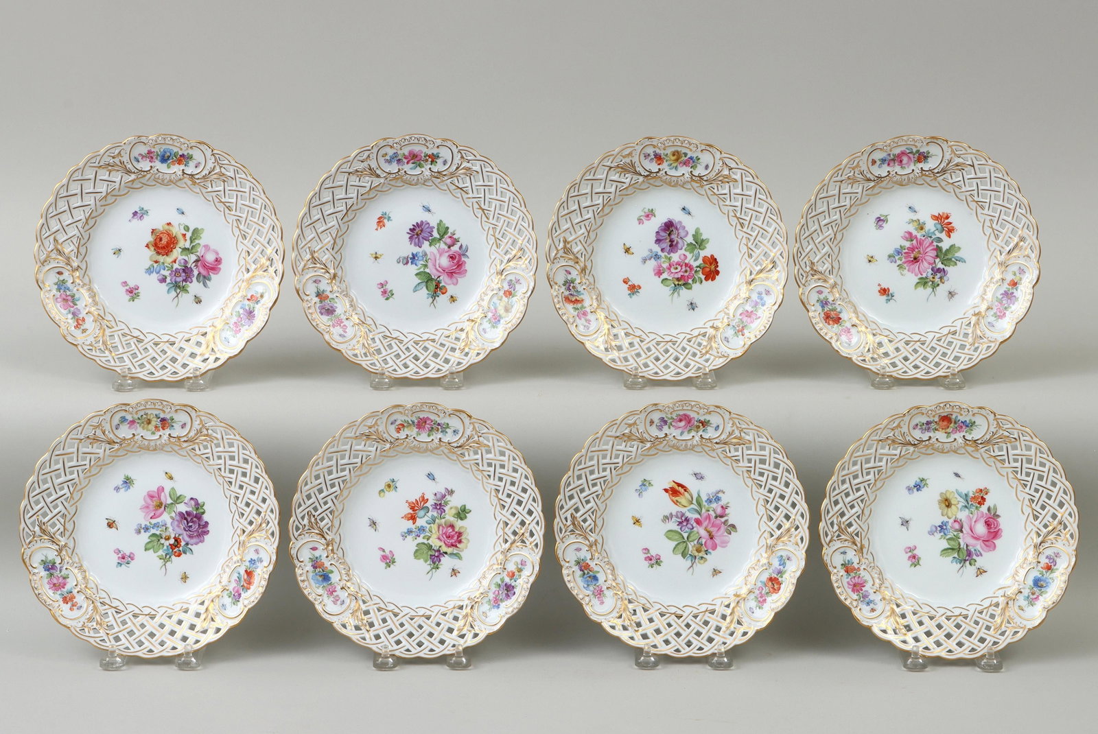 Set of (8) Meissen porcelain plates: Set of (8) Meissen porcelain plates, having floral design with insects and reticulated borders with gilt decoration, 19th/early 20th century, with crossed swords underglaze mark and impressed numbers 