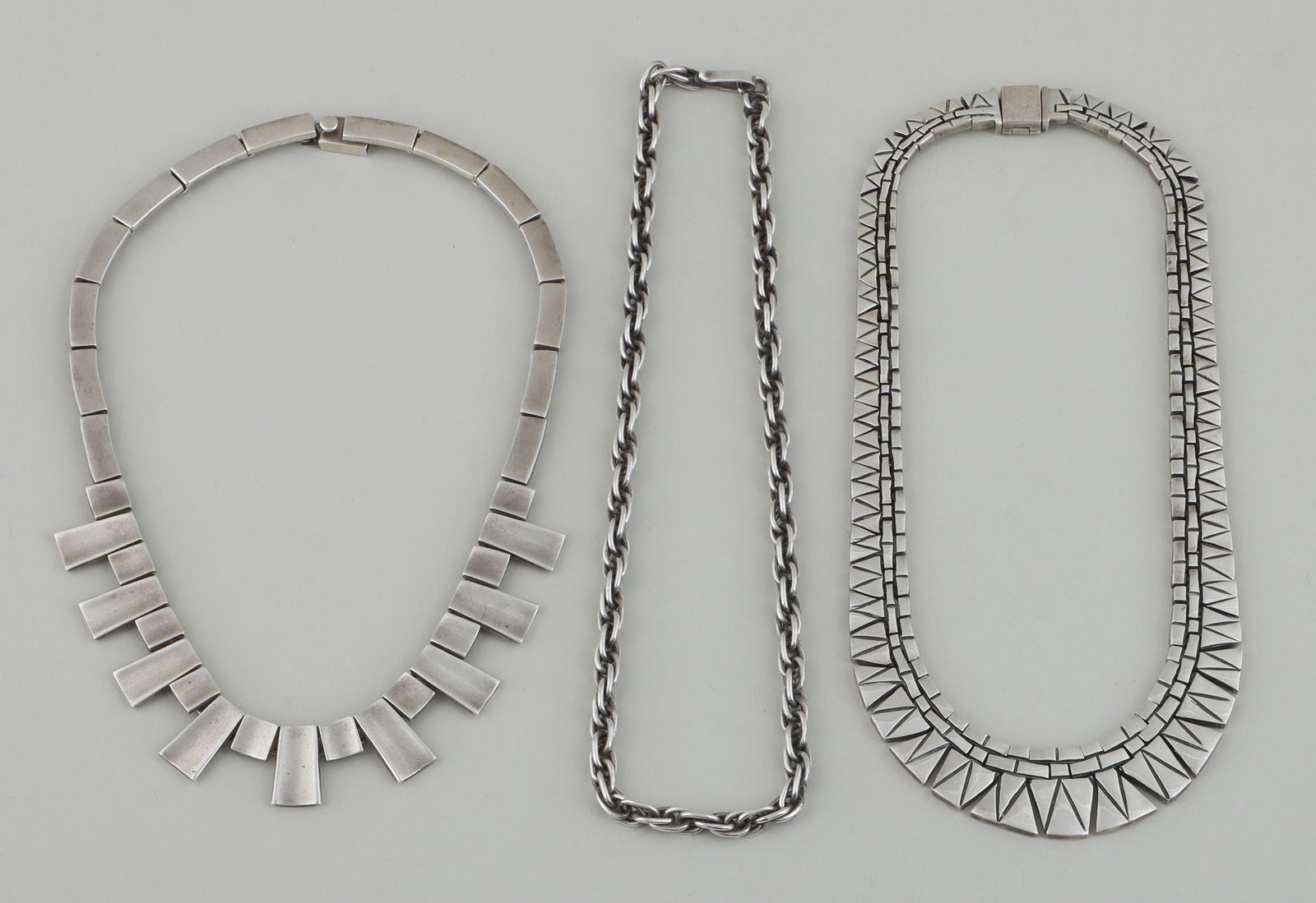Group of (3) Mexican sterling chain necklaces: Group of (3) Mexican sterling silver chain link necklaces, to include: (2) graduated necklaces having chain links with geometric design; and rope chain necklace. All marked. Minor scratches and wear. 