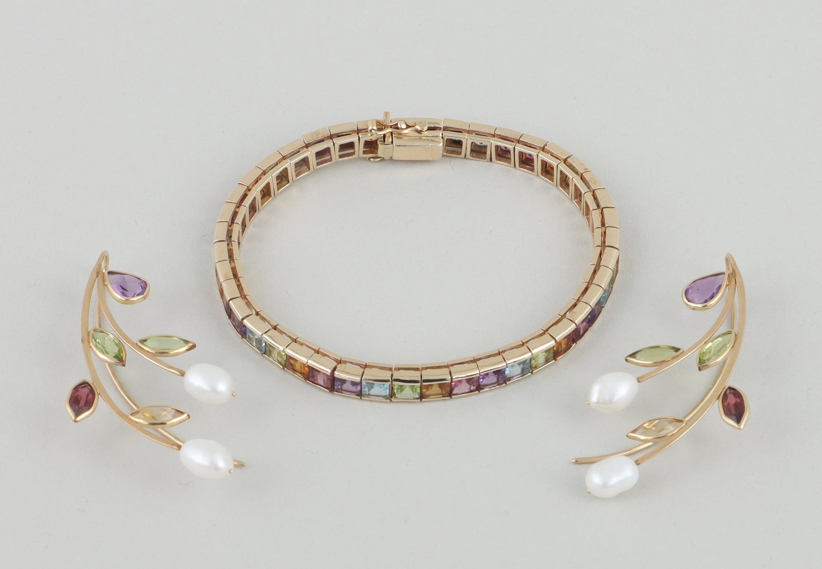 Set of (2) semi-precious stone 14k gold jewelry: Set of (2) multicolored semi-precious stone 14k gold jewelry, to include: ''rainbow'' tennis bracelet with repeating groups of (5) square-cut semi-precious stones arranged in the colors of the rainbow