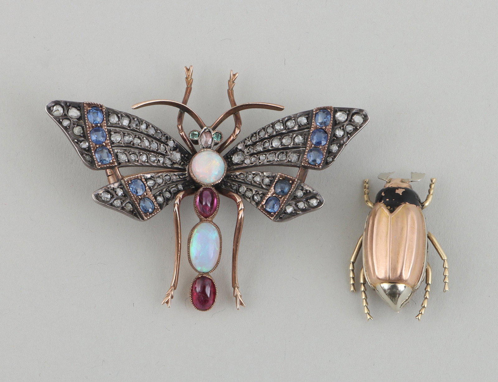 Group of (2) insect pins: Group of (2) insect pins, to include: 10k gold dragonfly brooch having wings with (78) rough-cut diamonds and (10) round and oval-cut sapphires, head with oval diamond and (2) square-cut emerald eyes,