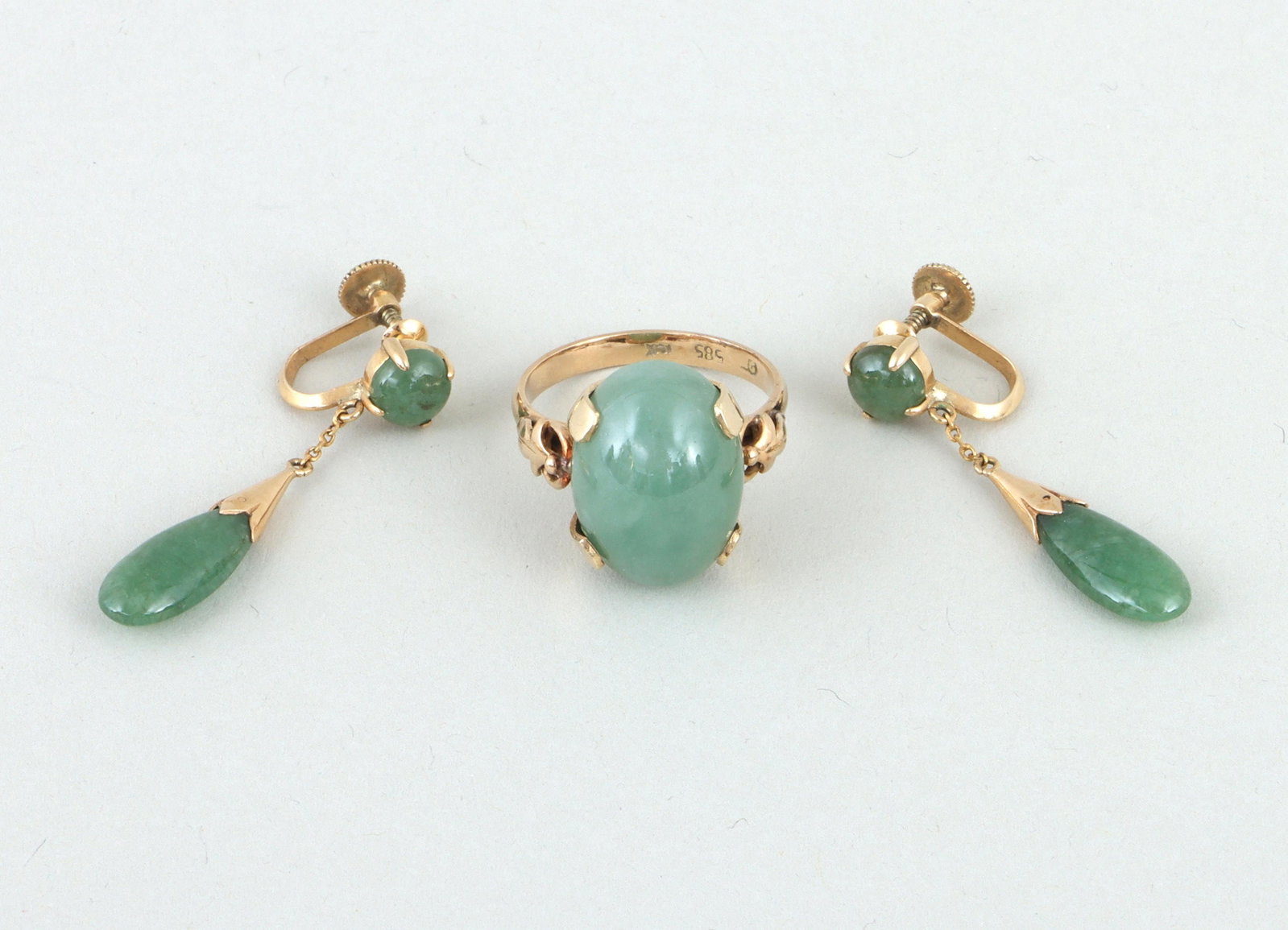 Group of (2) jade and 14k gold jewelry: Group of (2) jade and 14k gold jewelry, to include: ring with oval jade cabochon and shoulders with applied O-ring and foliate design, (stone slightly loose in setting); and pair of screw-back drop ea