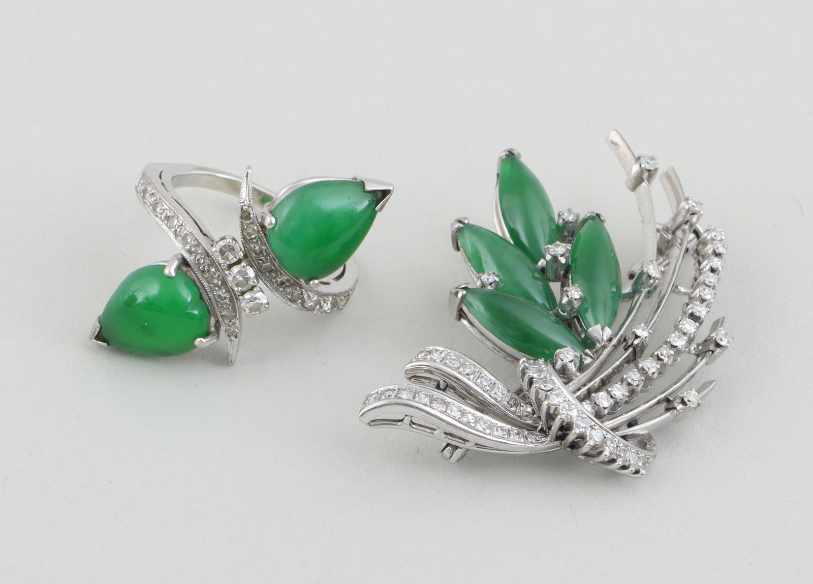 Set of (2) jadeite, diamond and 14k jewelry: Set of (2) jadeite, diamond and 14k white gold jewelry, to include: bouquet brooch with (5) jadeite marquise cabochons and (56) round-cut diamonds, marked on back, (minor wear to gold); and bypass rin