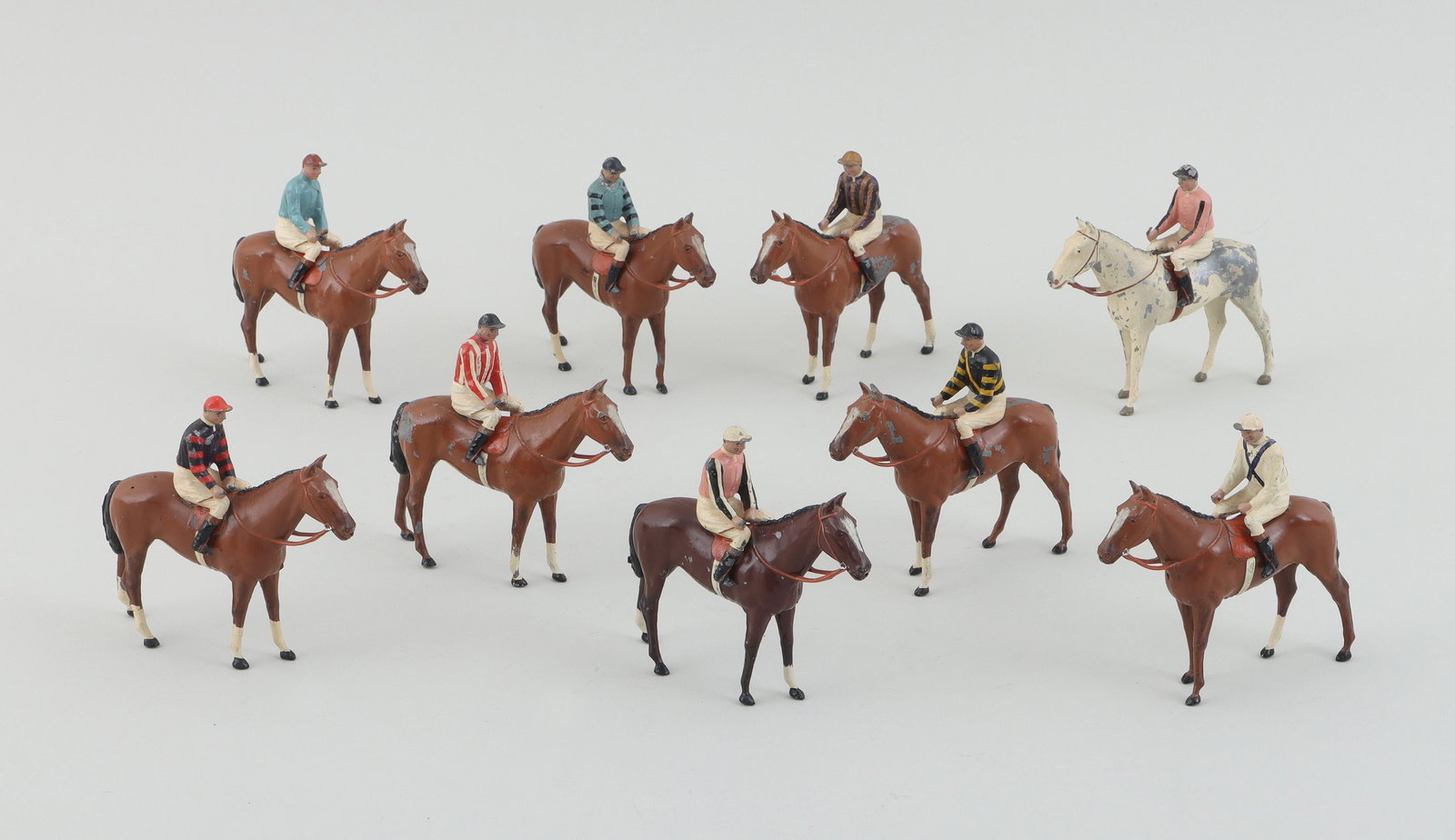'Racing Colours of Famous Owners'' horse toys: Group of (10) ''Racing Colours of Famous Owners'' cold-painted metal equestrian horse and jockey toys, with boxes labeled: Marshall Field; Mrs. Deering Howe; C. V. Whitney; John Hay Whitney; J. E. Wid