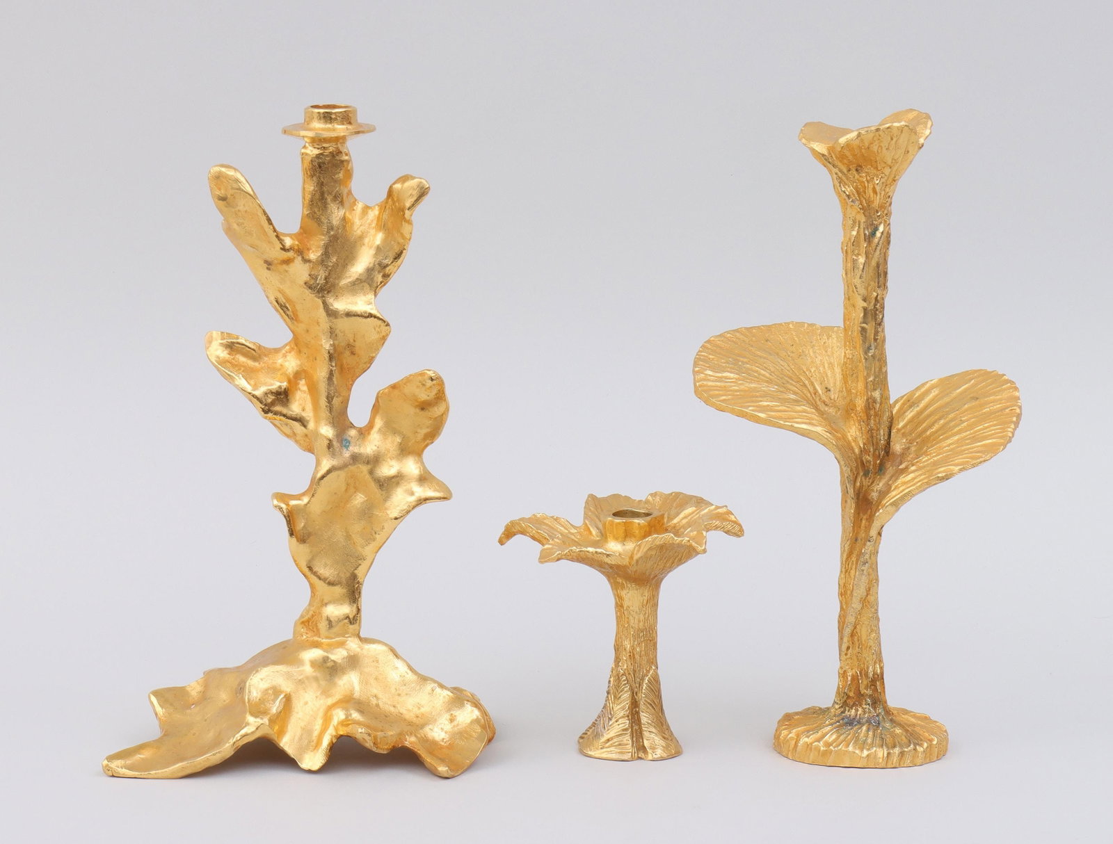 STEPHANE GALERNEAU (French, 20th/21st century): STEPHANE GALERNEAU (French, 20th/21st century), group of (3) gilt metal candlesticks, Paris, to include: short floriform candlestick; tall floriform candlestick, with Bergdorf Goodman tag adhered to b