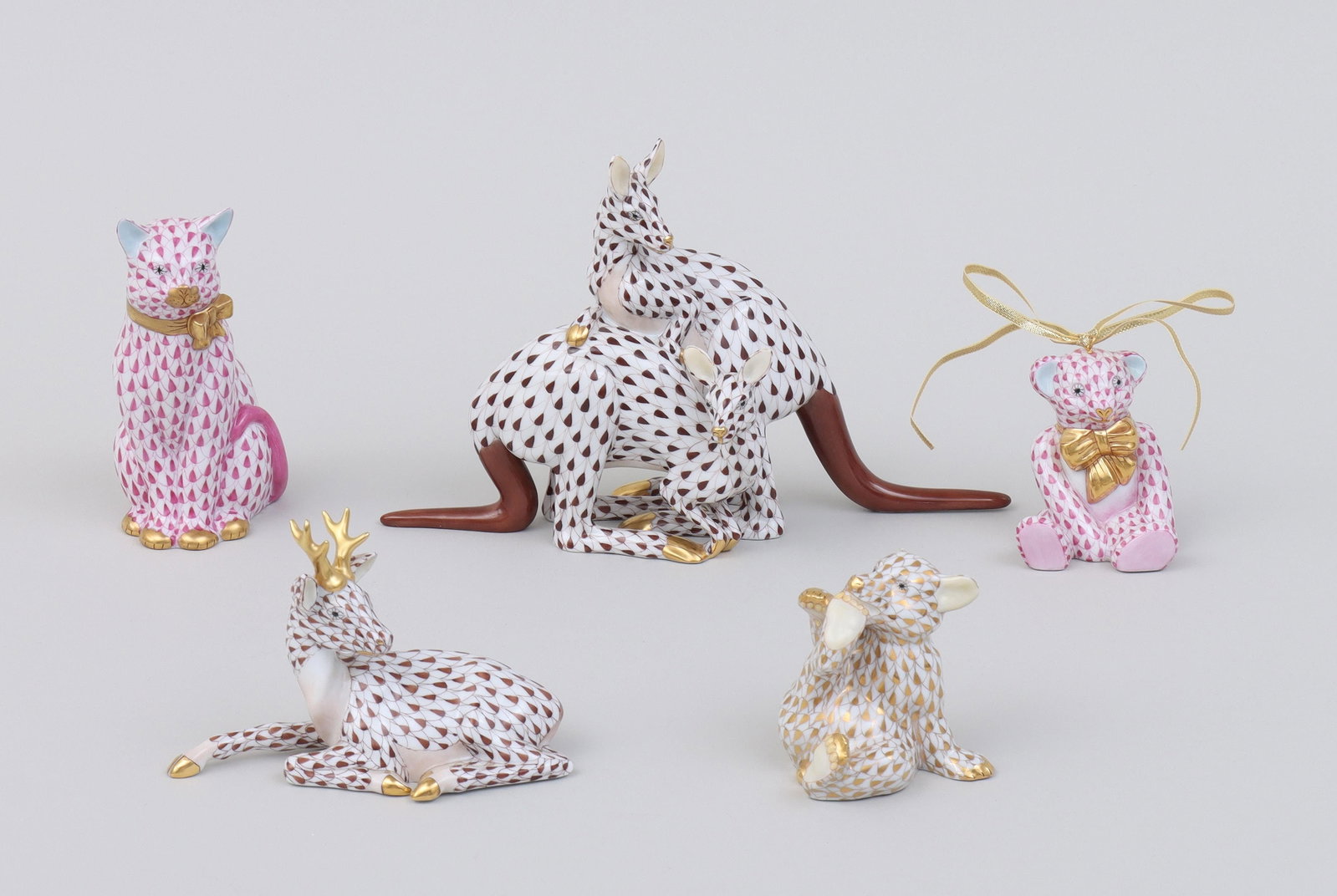 Group of (5) Herend porcelain animals: Group of (5) Herend porcelain animals in Fishnet pattern, with gilt accents, to include: figural group depicting two kangaroos, in brown; pink bear ornament; gold bear; pink cat; and light brown stag.
