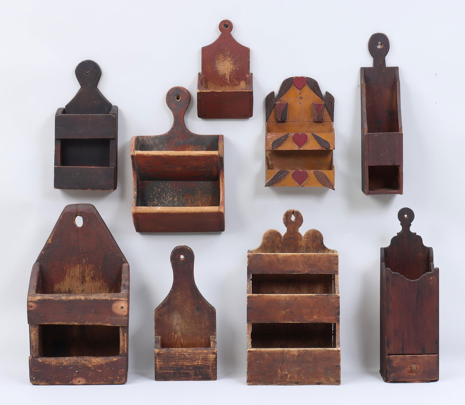 American country wall boxes: Group of (9) American country wall boxes, 18th/19th century, to include: 18th century New England pipe box with drawer, in dark finish, having wrought iron t-head nails, (split with loss to bottom, dr