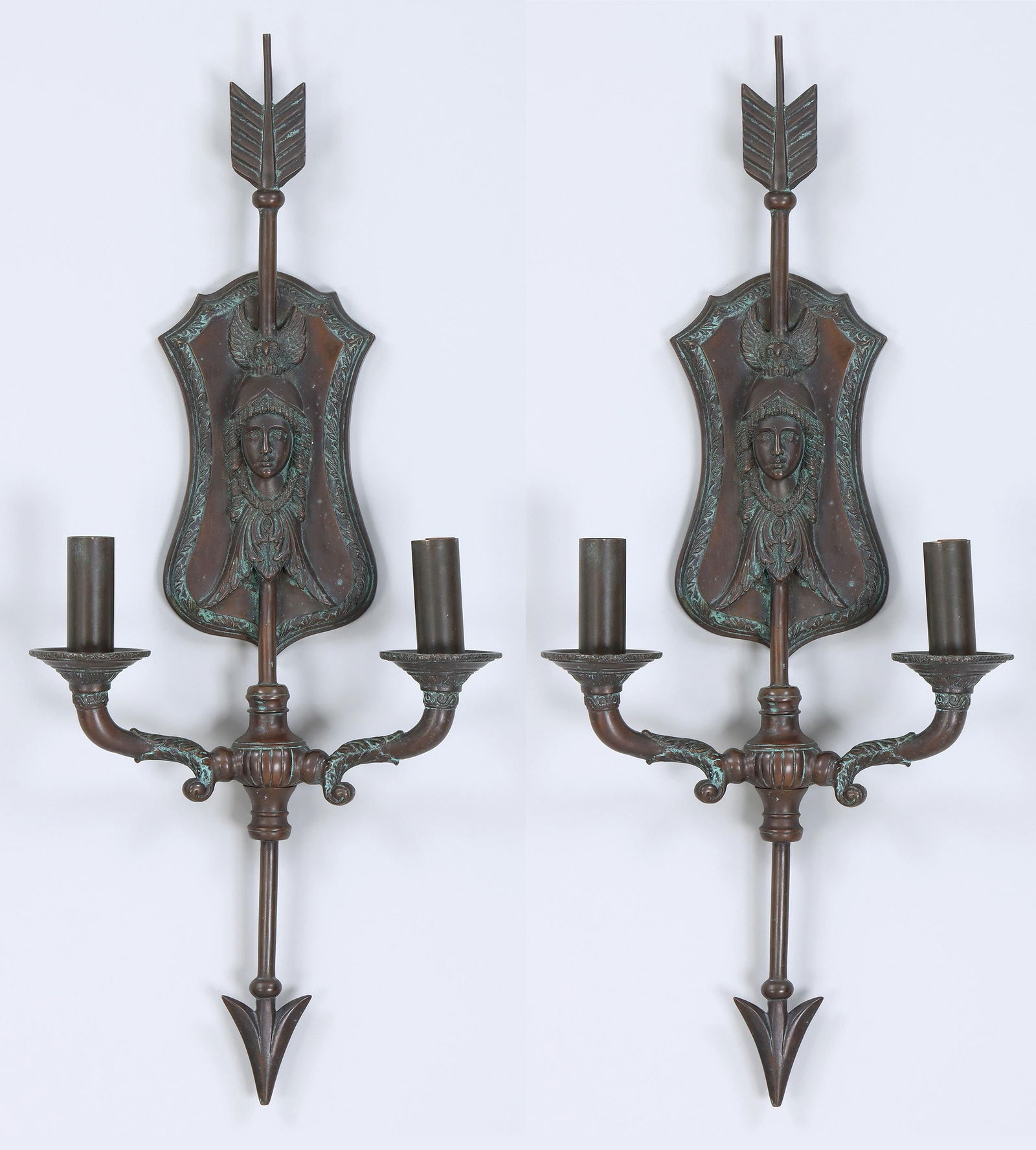 Pair of Directoire-style bronze two-light sconces: Pair of Directoire-style patinated bronze two-light sconces, most likely French, each shield-form backplate having mask of Athena in relief with her owl perched on her helmet, pierced by a downward ar