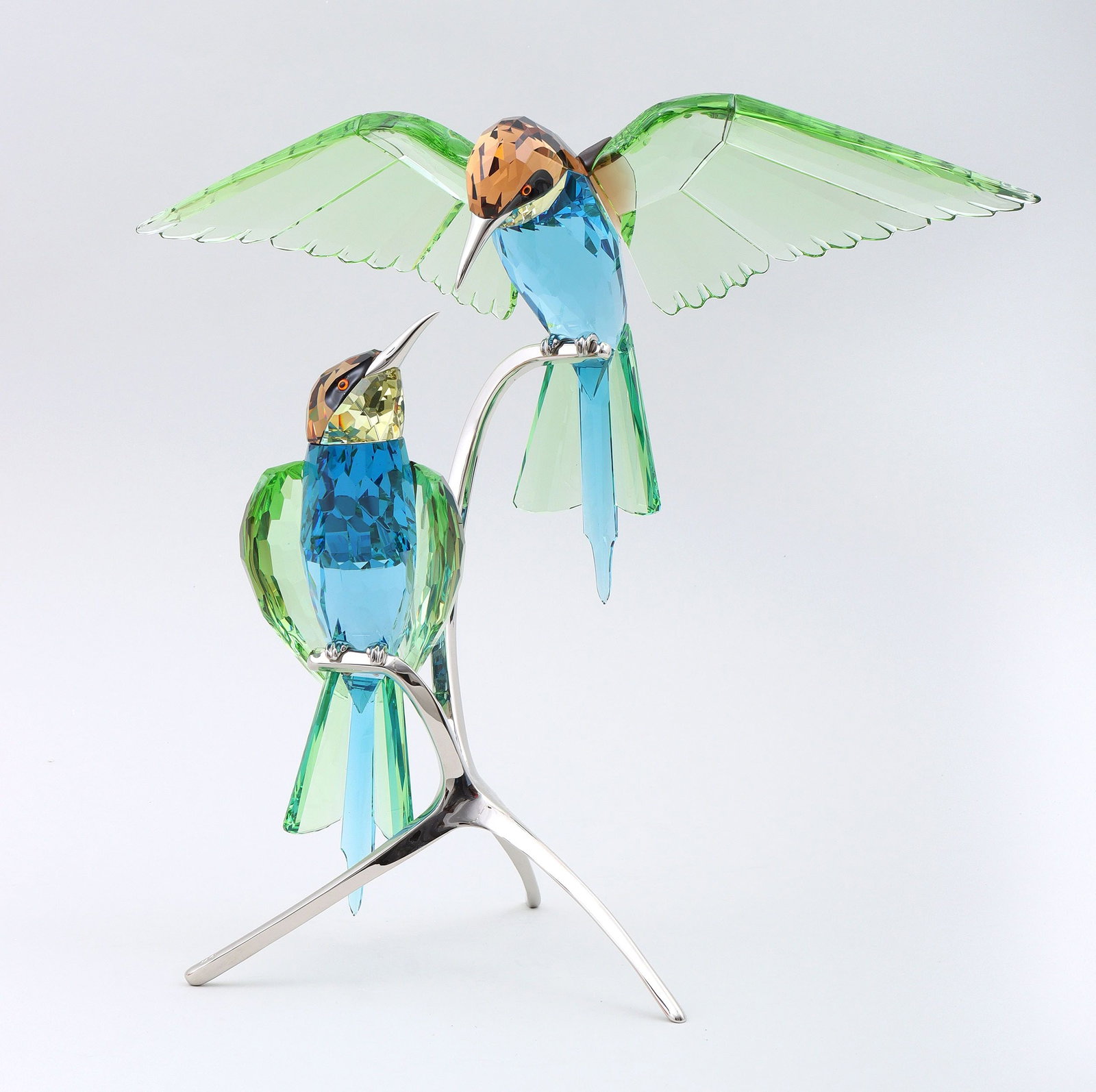 Swarovski ''Crystal Paradise'': Swarovski ''Crystal Paradise'' Bee-Eaters, 2000s/2010s, pair of crystal bird figures with metal beaks and feet, on metal tripod stand with ''swan'' mark impressed at end of one foot. Approximately 11-