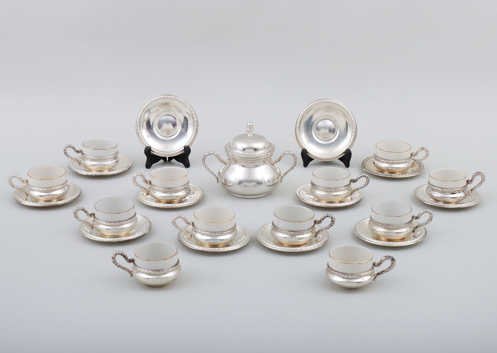 Set of silver and porcelain teacups with saucers: Set of (12) Italian .800 silver and porcelain teacups with saucers, Castaudi & Gautero di Emanuelli & Pastore, Vercelli, mid to late 20th century, all with gadrooned borders, comprising (12) teacups h