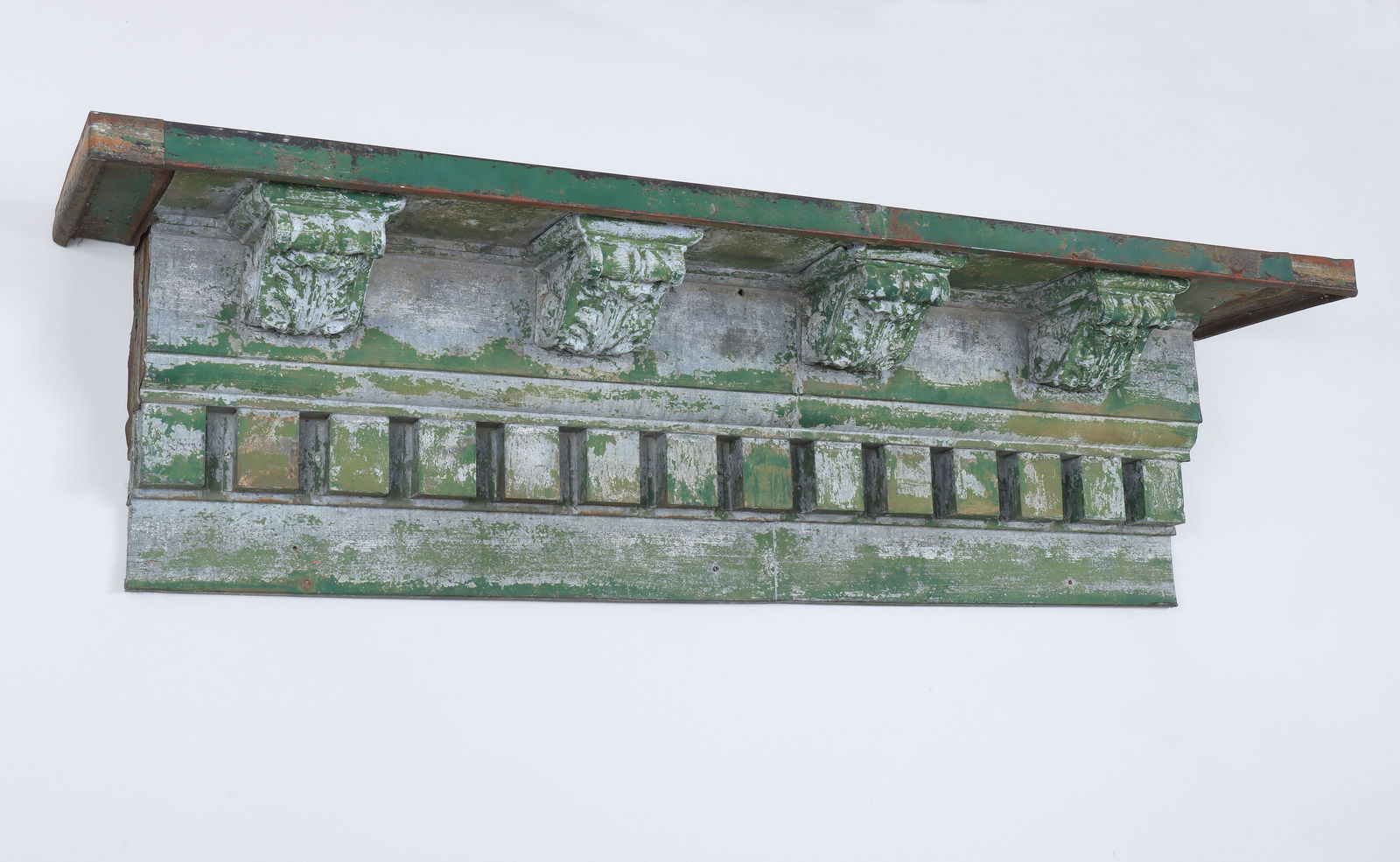 Painted tin cornice: Painted tin cornice with dental molding and acanthus corbels. Paint loss. 19-1/4''h, 73''w, 14''d. Provenance: From the prominent folk art collection of a Bridgehampton, NY estate.