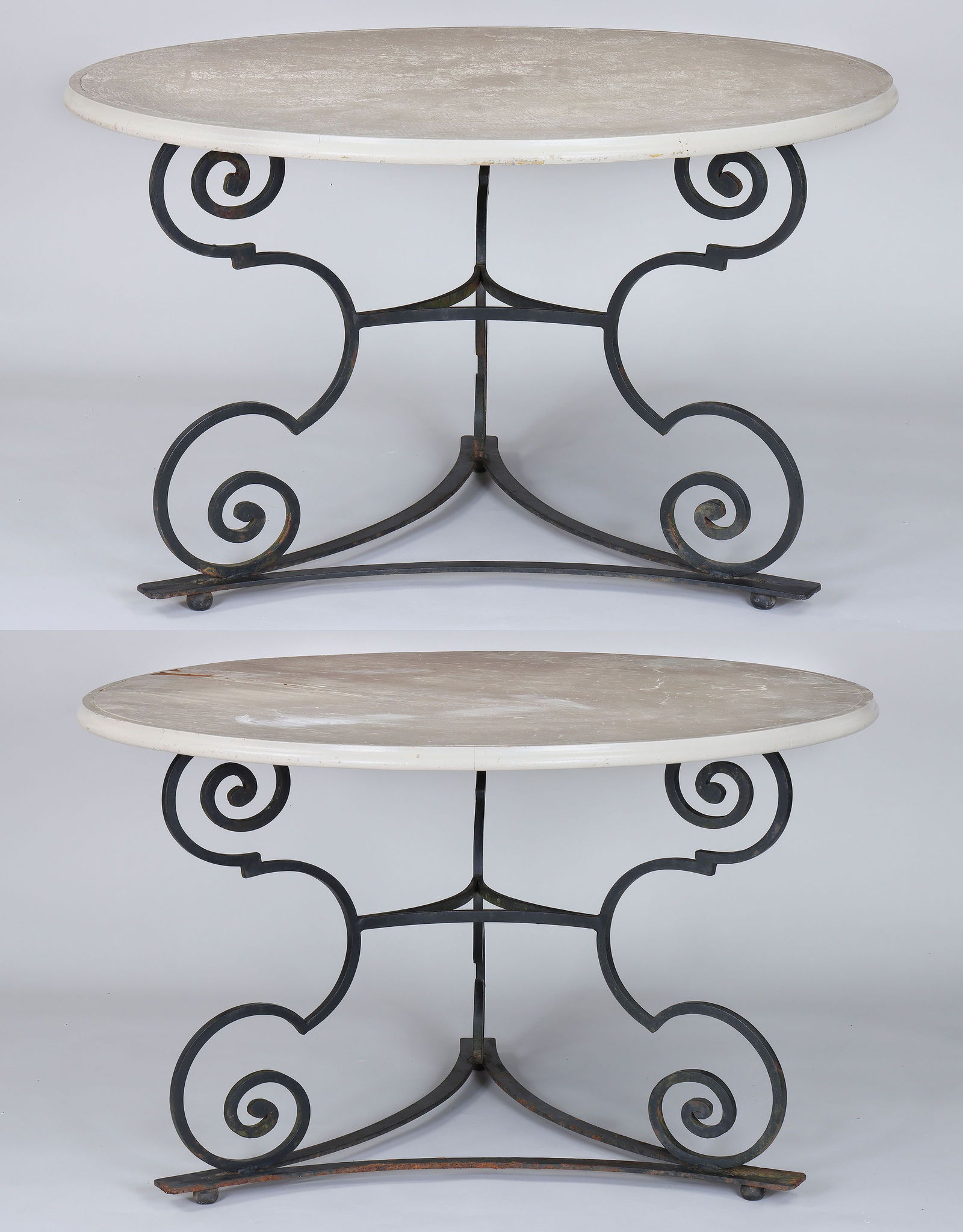 Pair of wrought iron tables: Pair of wrought iron tables with circular white-painted wood tops, having scroll tripod base with ball feet. One top with loss to surface and lifting. 29''h, 48''dia.