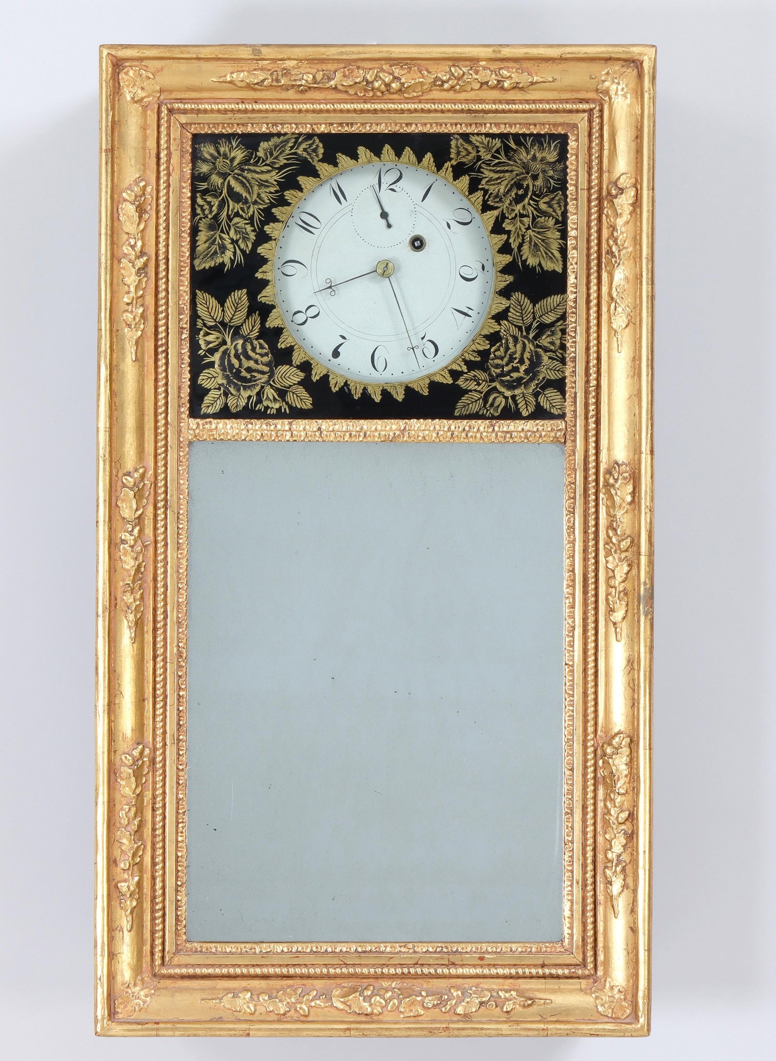 Attributed to Asa Munger, 19th Century Mirror Clock: Attributed to Asa Munger, 19th Century Mirror Clock Auburn, NY, the hand-painted dial with Arabic numerals behind eglomise glass with gilt floral design, over a rectangular mirror, all in giltwood fra