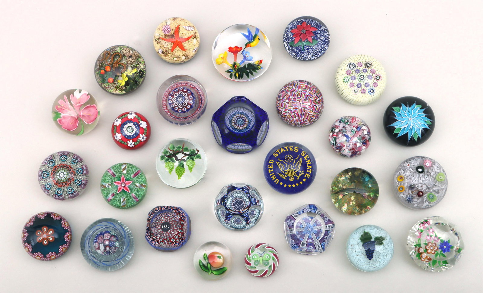 Group of (27) Glass Paperweights: Group of (27) Glass PaperweightsTo include: hummingbird by Rick Ayotte; snake by Gordon Smith; starfish by William Manson; green grapes by Randall Grubb; purple grapes by Harold J. Hacker; Bicentennia