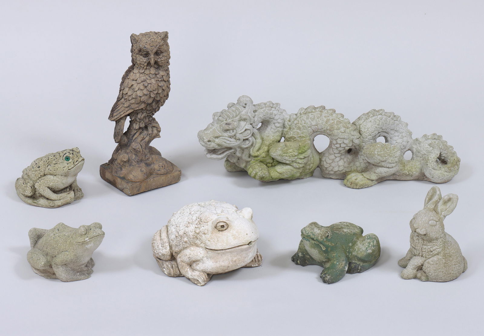 Group of (7) Small Cast Stone Animals: Group of (7) Small Cast Stone Animalsto include: (2) frogs; (2) toads, one a fountainhead; owl, marked "Marwal Ind."; dragon; and rabbit.Dragon 7 1/4 x 24 1/2 x 7 in.
