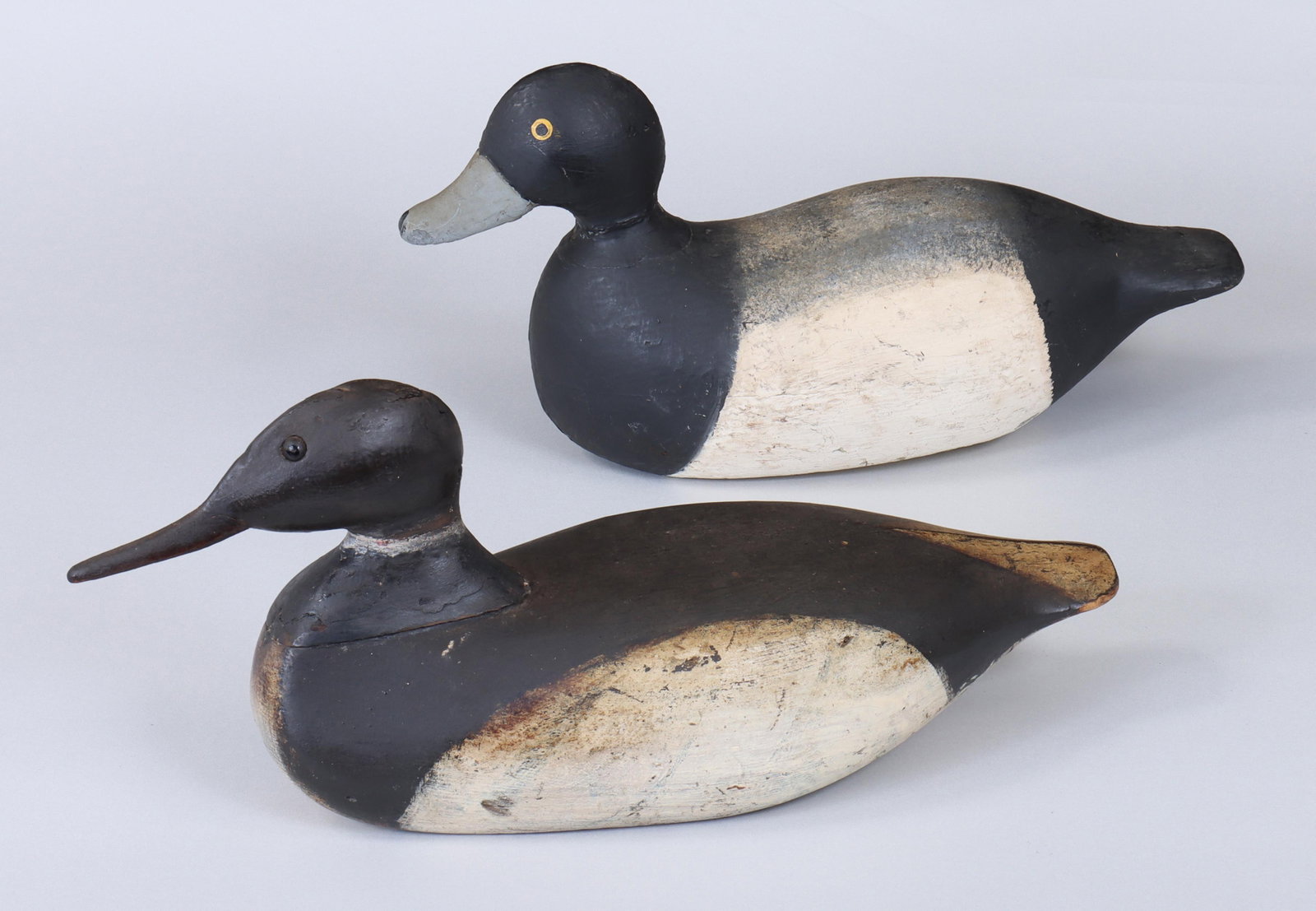Group of (2) New England Decoys: Group of (2) New England Decoys to include: merganser with glass eyes, (possible head replacement or repair, round bottom weight removed and overpainted); and drake hollow broadbill with painted eyes,
