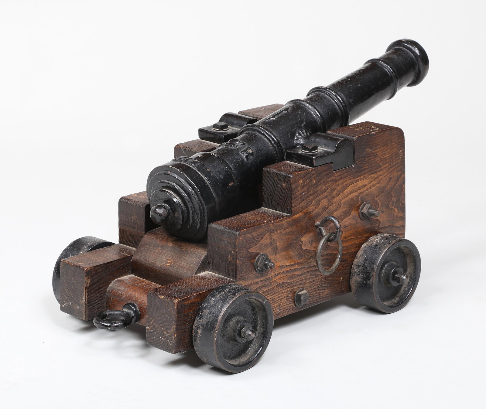 Small George II Replica Cast Iron Cannon: Small George II Replica Cast Iron Cannon set on wood carriage, painted black with relief crown, ''GR'', ''XVII'' and double ended arrows. Barrel length 21-1/2"