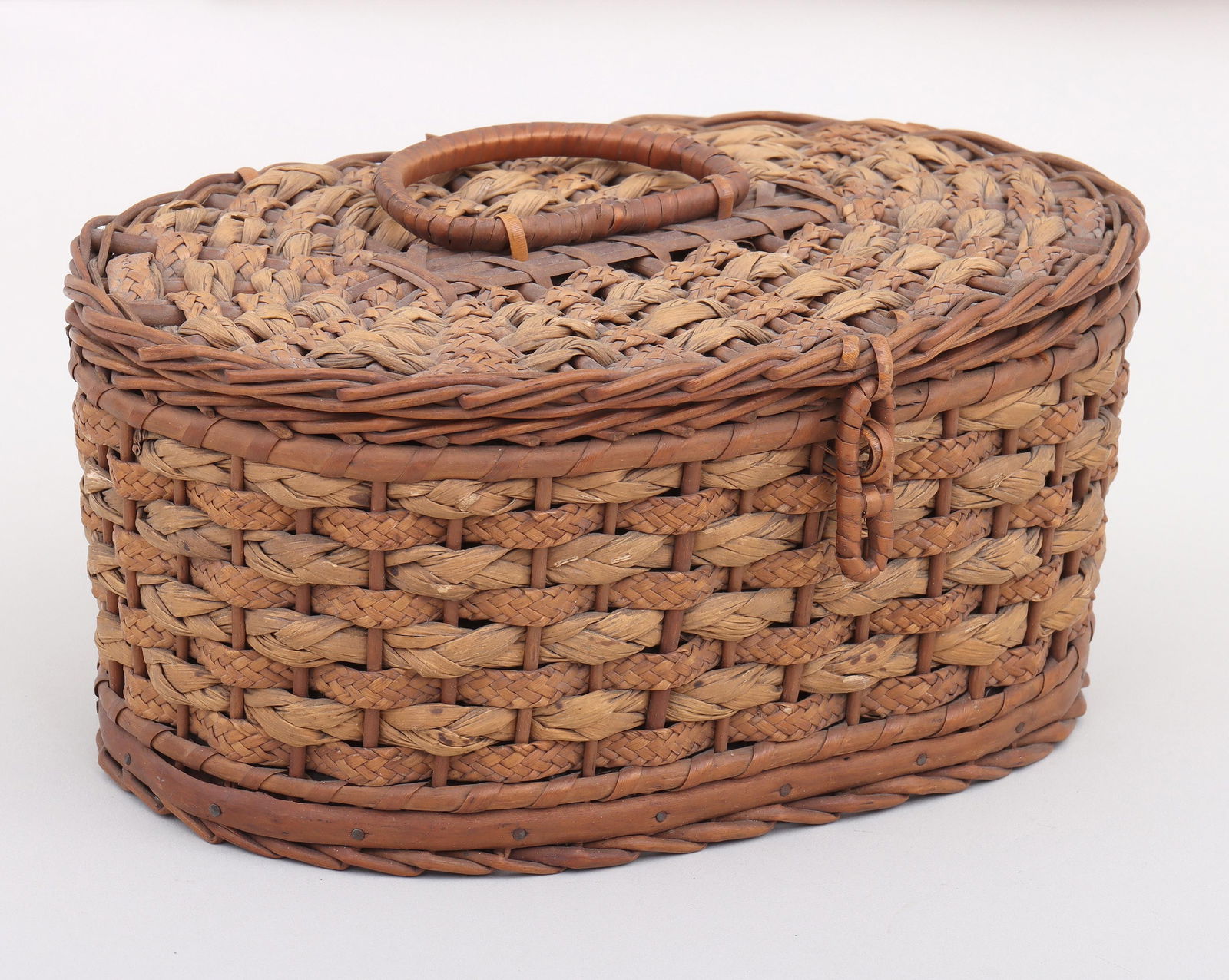 Huntley & Palmers Biscuit Tin and Basket: Huntley & Palmers Biscuit Tin and Baskethaving tin with gold-tone lid inside a wicker basket with hinged lid and articulated handle, Huntley & Palmer marks on top of tin and bottom of basket.3 5/8 x 8