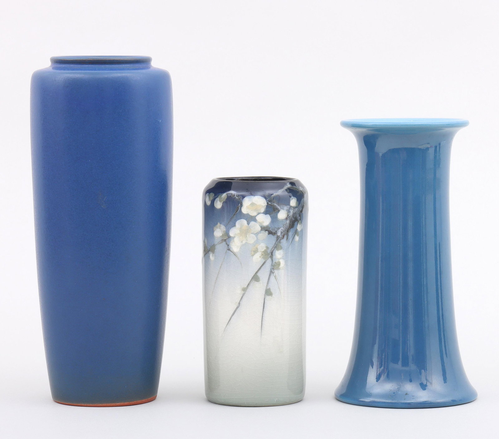 Group of (3) Art Pottery Vases: Group of (3) Art Pottery Vases to include: Rookwood small cylindrical vase with branches of apple blossoms, by Katherine Van Horne, 1907, in “Iris Glaze”, marked and numbered on bottom; Bretby