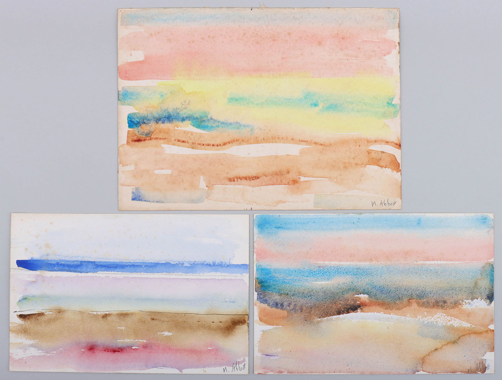 Mary Abbott (American 1921-2019), (3) Abstract Seascapes: Mary AbbottAmerican, 1921-2019Group of (3) Abstract Seascapeswatercolor on papercirca 1960s-70s, signed in pencil lower right, to include: "Dawn Sea II", signed and titled on frame verso; "Soft Sea",