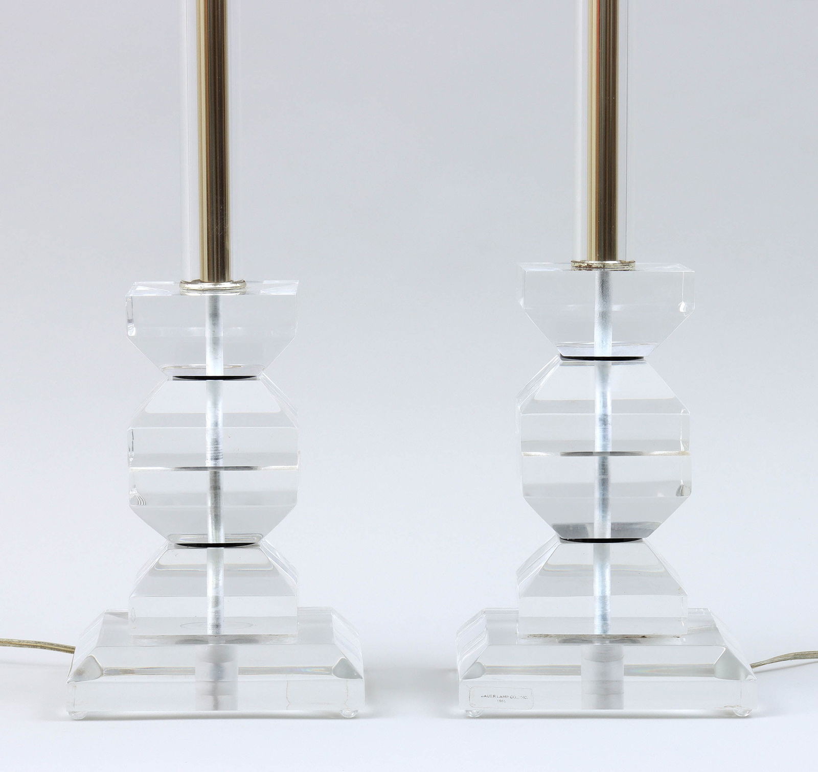 Pair of Modern Lucite Table Lamps: Pair of Modern Lucite Table LampsBauer Lamp Company, with square bases, stacked geometric blocks and column with interior brass rod, Bauer Lamp Company label on side of bases.Overall 37 1/2 in. (95.3