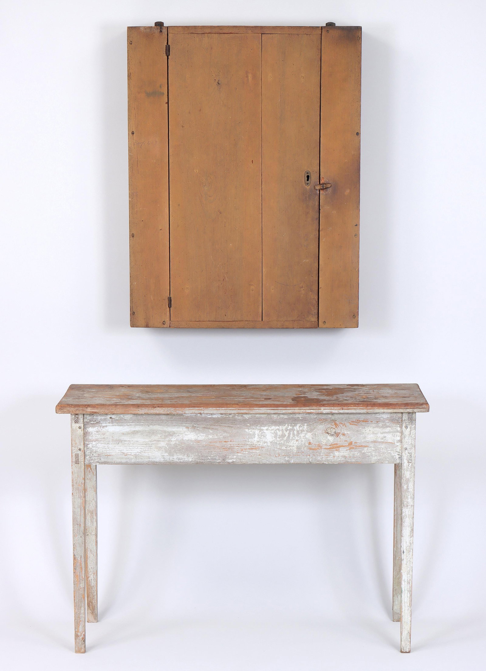 Group of (2) 19th Century American Country Furniture: Group of (2) 19th Century American Country Furniture to include: console table with mortis-and-tenon construction and square tapering legs, in distressed white paint; and ochre-painted wall cabinet. T