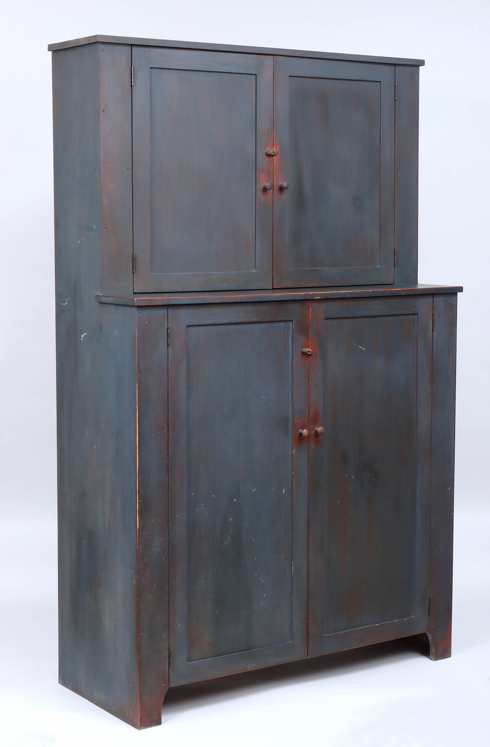 Simms & Thayer "Country Step Back Hutch": Simms & Thayer "Country Step Back Hutch" in dark blue paint, having a two-door cabinet top and bottom with shelved interior, branded mark to back, 20th century. 72 1/2 x 45 x 18 3/4 in. (184