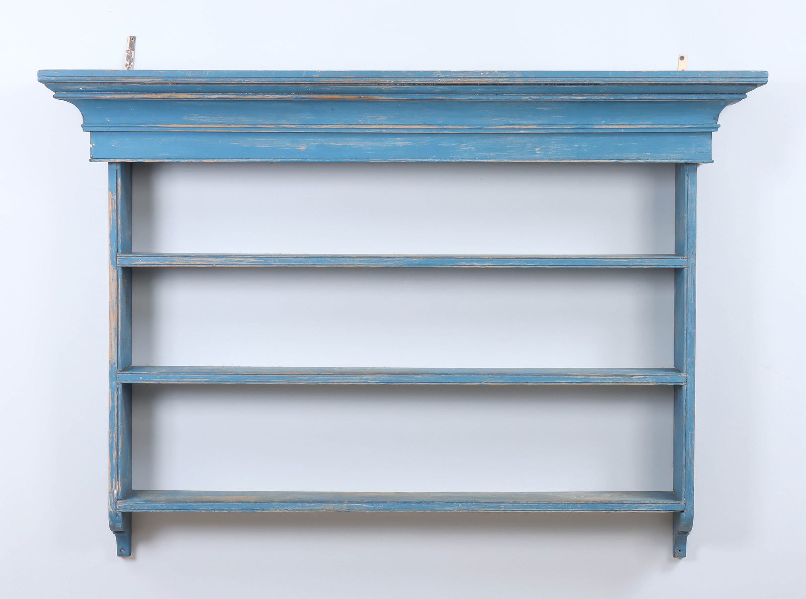 Blue-painted Wall Shelf: Blue-painted Wall Shelfwith molded cornice and three shelves, late 19th or early 20th century.38 1/4 x 55 1/2 x 11 3/4 in. (97.2 x 141 x 29.8 cm.) Provenance: Property of a South Shore, Long Island co