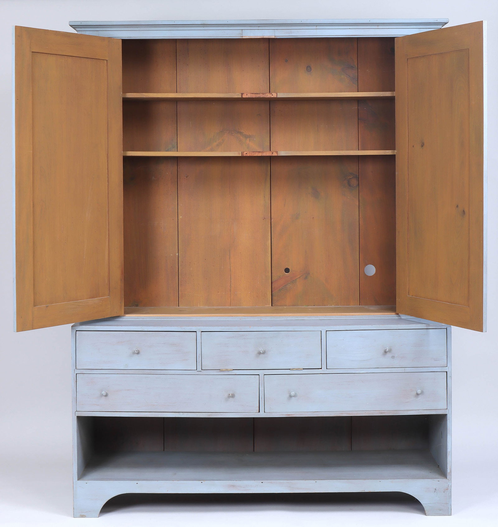 Simms & Thayer "Connecticut Cupboard": Simms & Thayer "Connecticut Cupboard" in two parts, having two paneled upper doors, set on a base with (4) drawers and a central fall-front compartment over a large open shelf, in pale blue,
