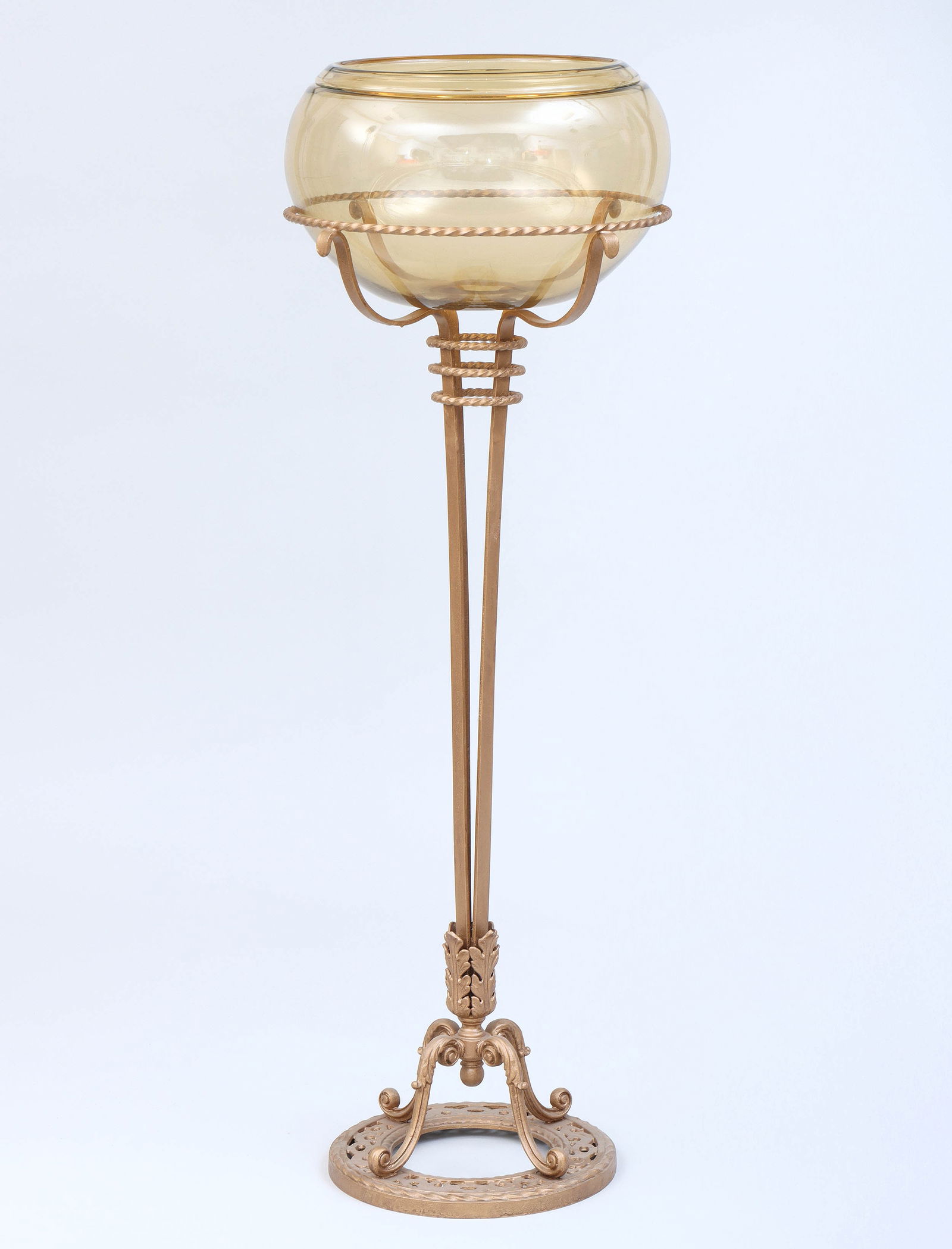 Victorian Fishbowl on Iron Stand: Victorian Fishbowl on Iron Standhaving amber glass fishbowl and gold-painted wrought iron stand with twist borders, the tapering standard ending in Acanthus leaves, over leaf-topped scroll legs, on a