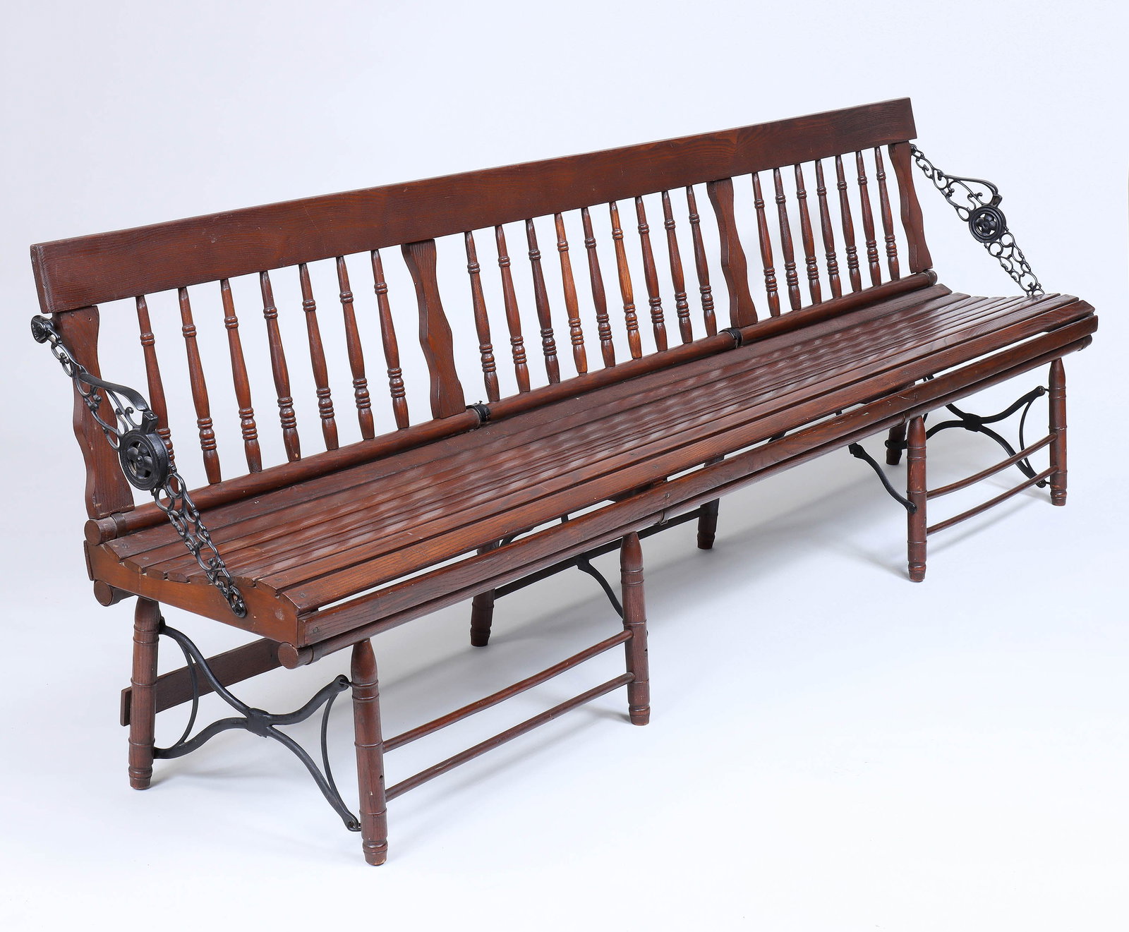 Railroad Station Folding Bench: Railroad Station Folding Bench 19th century, with spindle back and slat seat, having cast iron folding armrests at each end, on turned legs with cast iron x-form side supports and locking brackets. 32