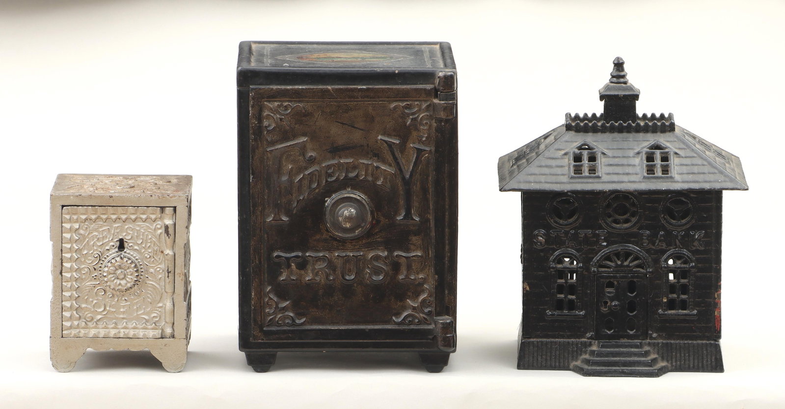 Group of (3) Painted Cast Iron Still Banks: Group of (3) Painted Cast Iron Still Banks to include: Henry C. Hart Mfg. Co. ''Fidelity Trust'' safe with combination lock, left and right sides with decals depicting three-quarter length portraits o