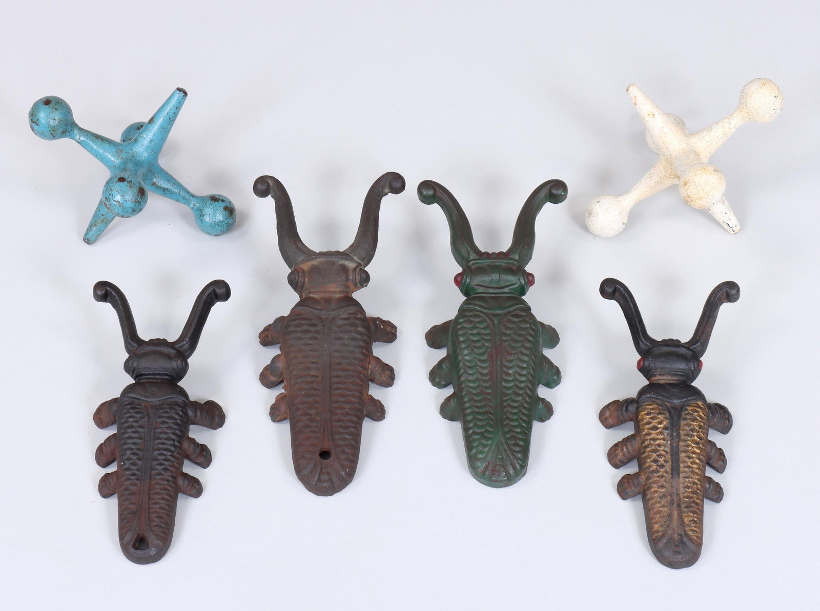 Group of (6) Cast Iron Bootjacks and Doorstops: Group of (6) Cast Iron Bootjacks and Doorstops to include: (4) beetle-form bootjacks, comprising green-painted, having "D" with arrow mark and "Made in USA", black-painted with gol
