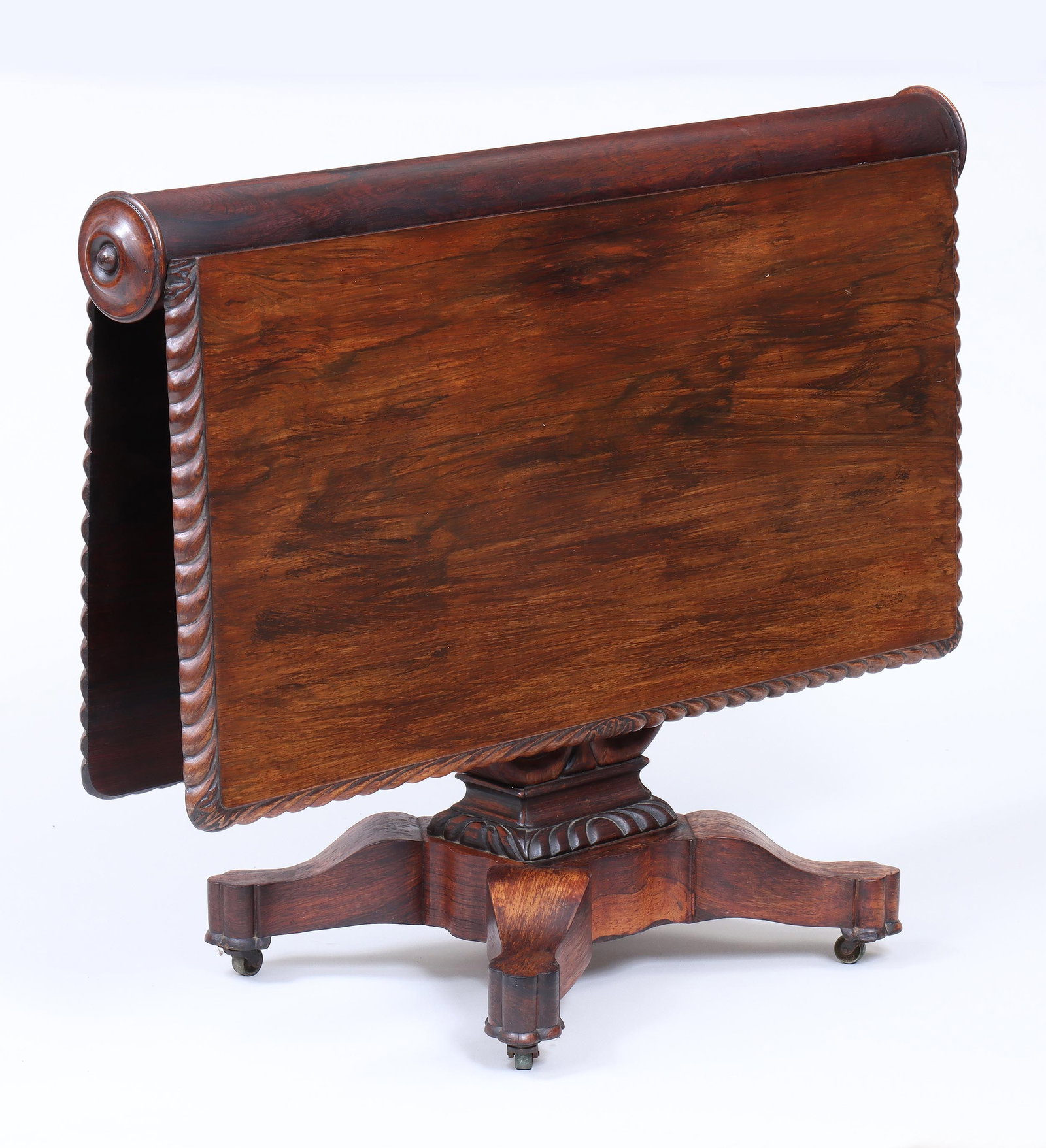 English Rosewood Sunderland Table: English Rosewood Sunderland Table having square dropleaf top with gadroon-carved edges, and openwork brackets, on pedestal base with lyre-form standard ending in shaped trefoil feet on casters. Open 2