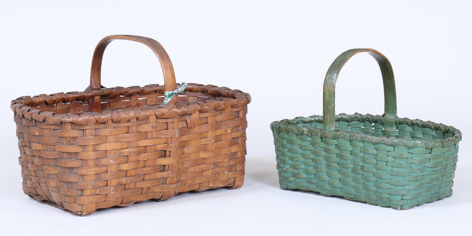 Group of (2) Taghkanic Gathering Baskets: Group of (2) Taghkanic Gathering Baskets with oak splints and hickory rims and handles, to include: large 19th century basket; and green-painted basket, Columbia County, New York. Larger 13-3/4"h x 20