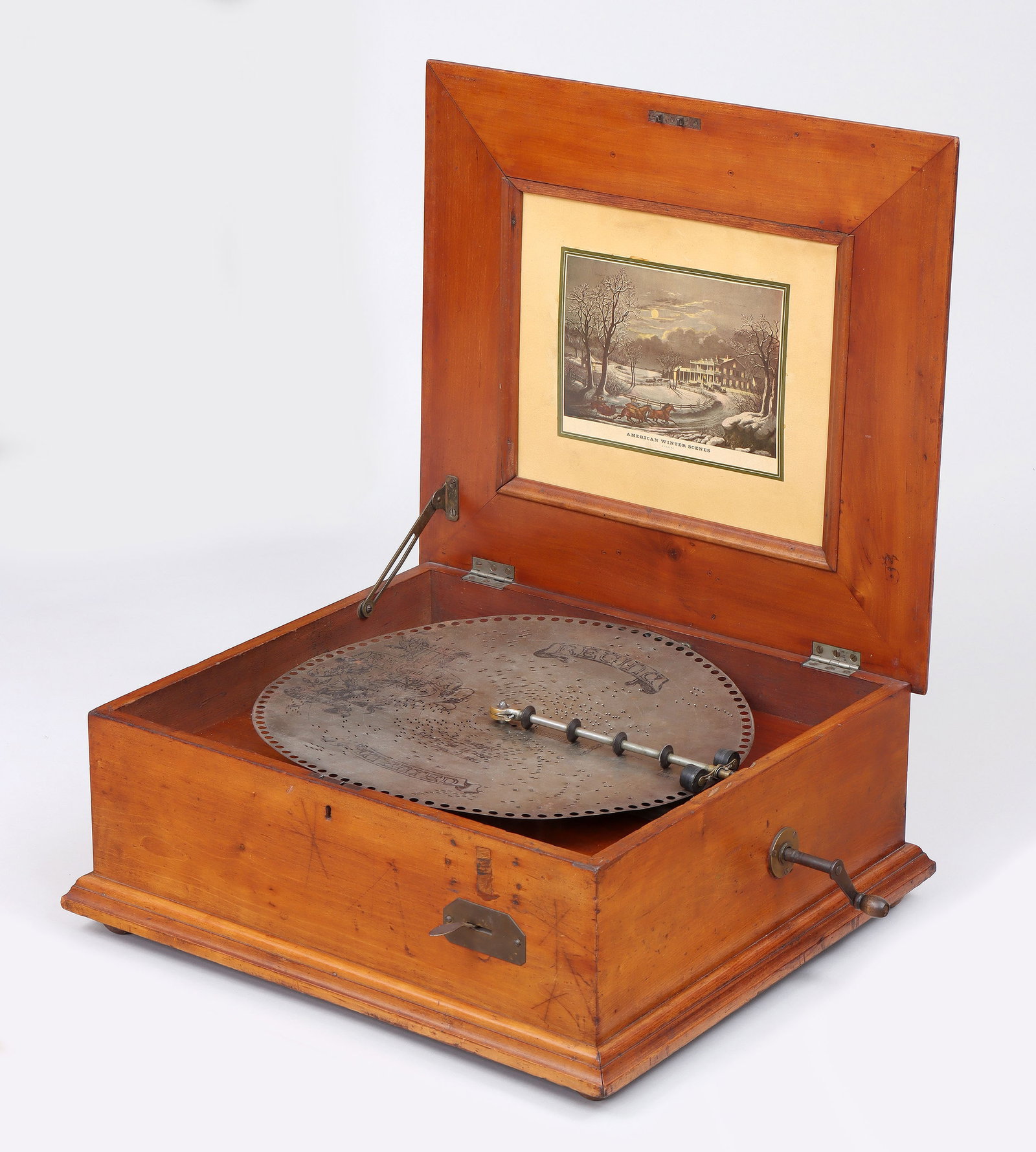 Regina Tabletop Music Box: Regina Tabletop Music Boxsingle comb, works stamped "293", in cherry wood case having paneled lid, the interior with inset chromolithograph after Currier & Ives "American Winter Scenes&
