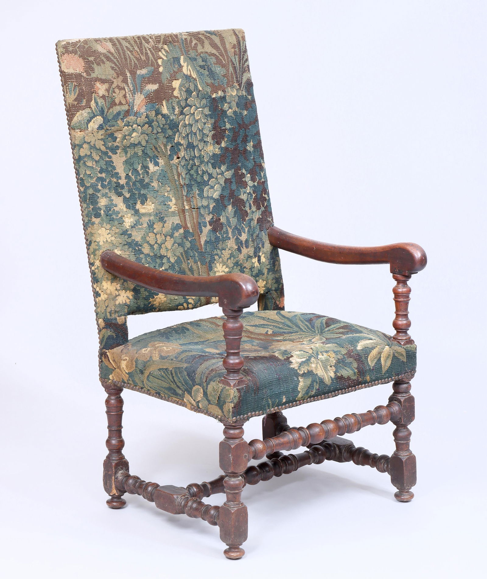 17th/18th Century Continental Armchair: 17th/18th Century Continental Armchairhaving period verdure tapestry upholstery with brass tacking, on block-and-turned legs.43 1/2 x 27 x 23 1/4 in. (110.5 x 68.6 x 59.1 cm.)