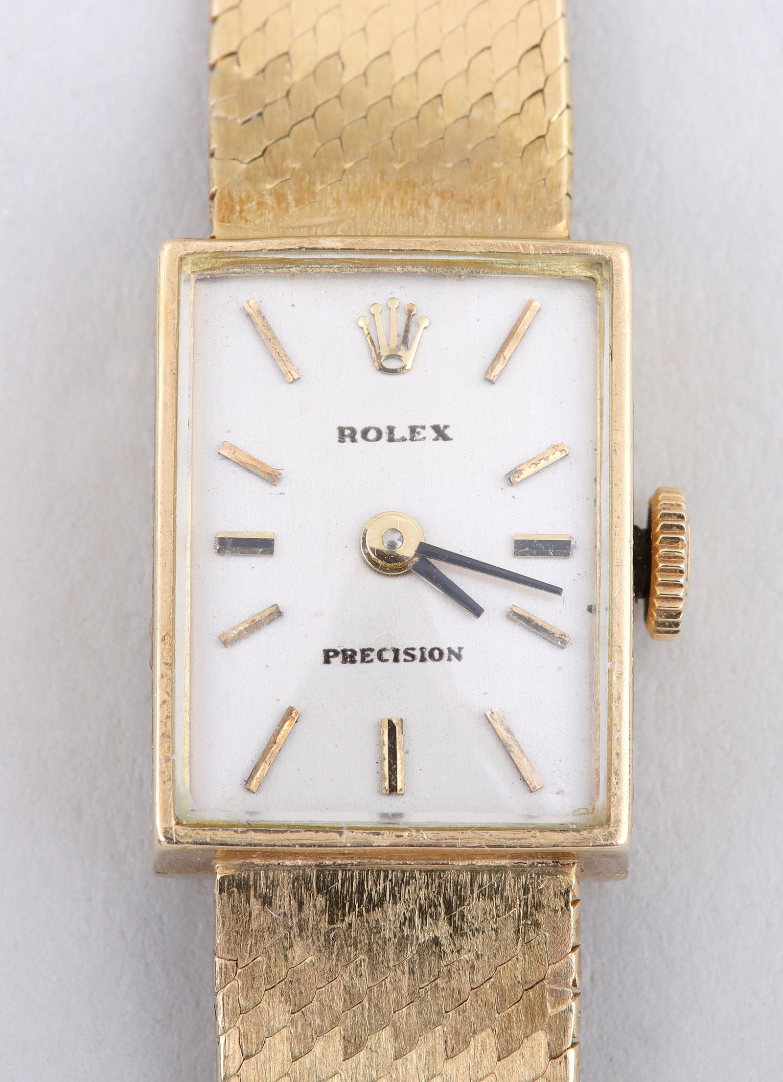 Rolex 18k Gold Ladies' Wristwatch: Rolex 18k Gold Ladies' Wristwatch17 jewels, Geneva, Switzerland, c. 1973, with rectangular face, on woven gold Bucherer band, case numbered ?2631? and ?22?, marked and numbered inside case, on movemen
