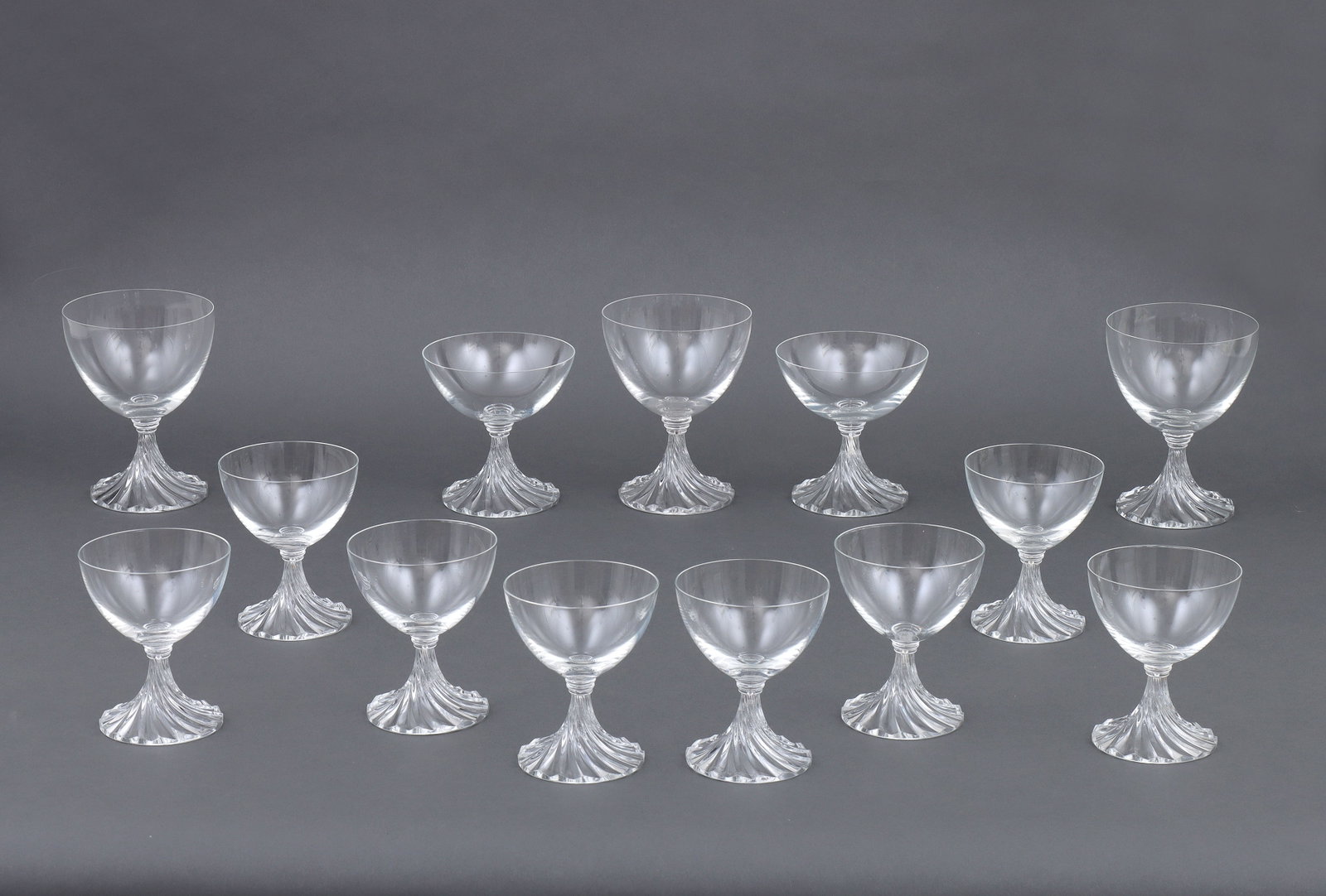 Set of (13) Lalique "Rambouillet" Crystal Glasses: Set of (13) Lalique "Rambouillet" Crystal Glasses with swirl bases, to include: (3) water goblets; (8) bordeaux wine; and (2) champagne glasses. All incised "Lalique France" on bot