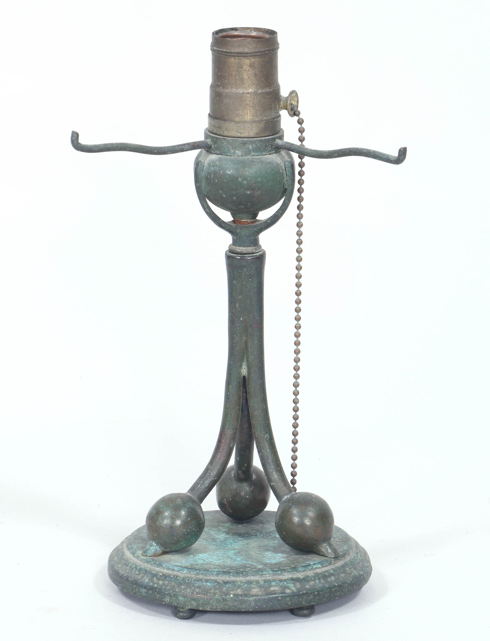 Tiffany-Style Patinated Bronze Lamp Base: Tiffany-Style Patinated Bronze Lamp Base having tripartite standard ending in spheres, over a stepped round plinth with pad feet, unmarked. Overall height 10 7/8 in. (27.6 cm.), diameter of base 5 1/8