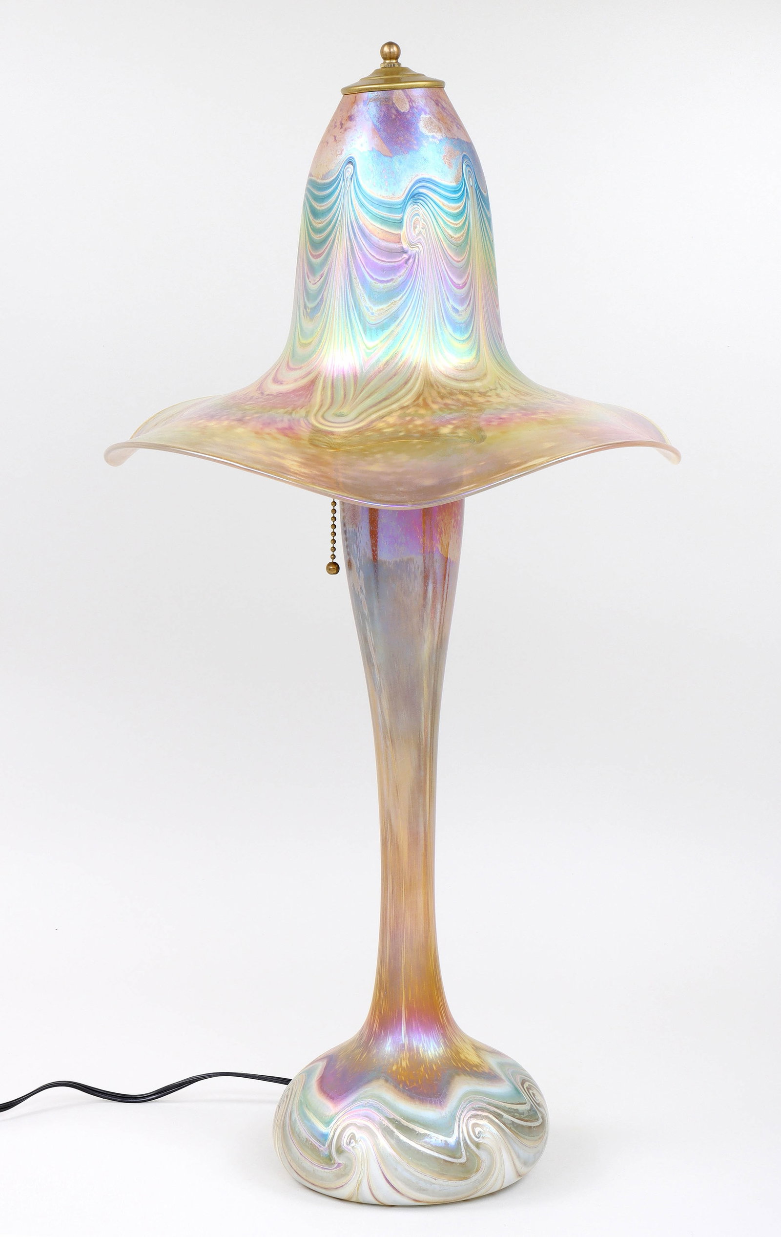 Attributed to Stephen Fellerman (American b. 1951), Iridescent Blown Glass Table Lamp: Attributed to Stephen Fellerman American, b. 1951 Iridescent Blown Glass Table Lamp having floriform glass shade with pulled feather design and undulating rim, over body of bulbous form with swirl des