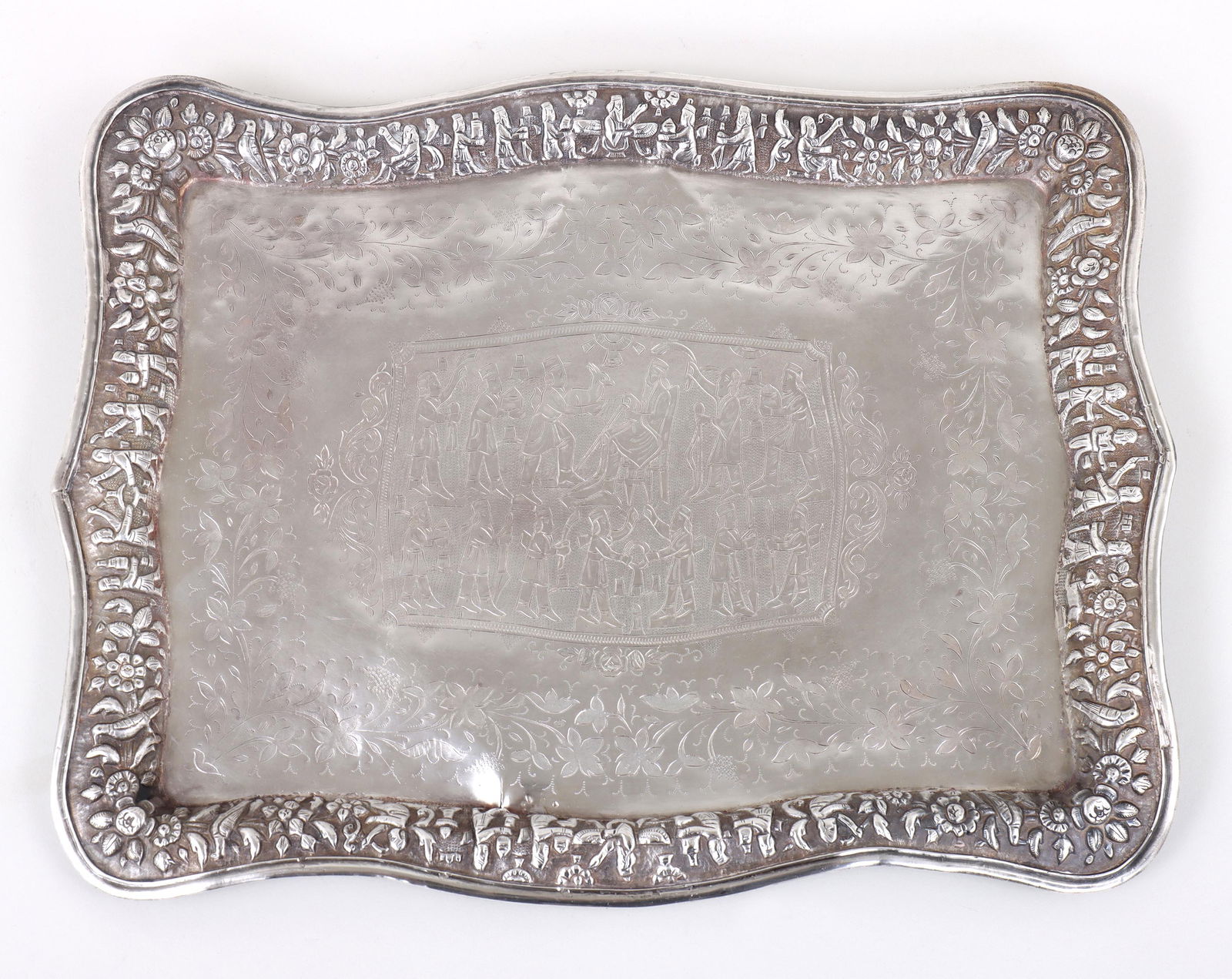 Persian (Iranian) Silver Tray: Persian (Iranian) Silver Trayhaving central scene with figures surrounded by chased and engraved scrolled floral design, all enclosed by a repousse edge with figures, birds and floral design, unmarked
