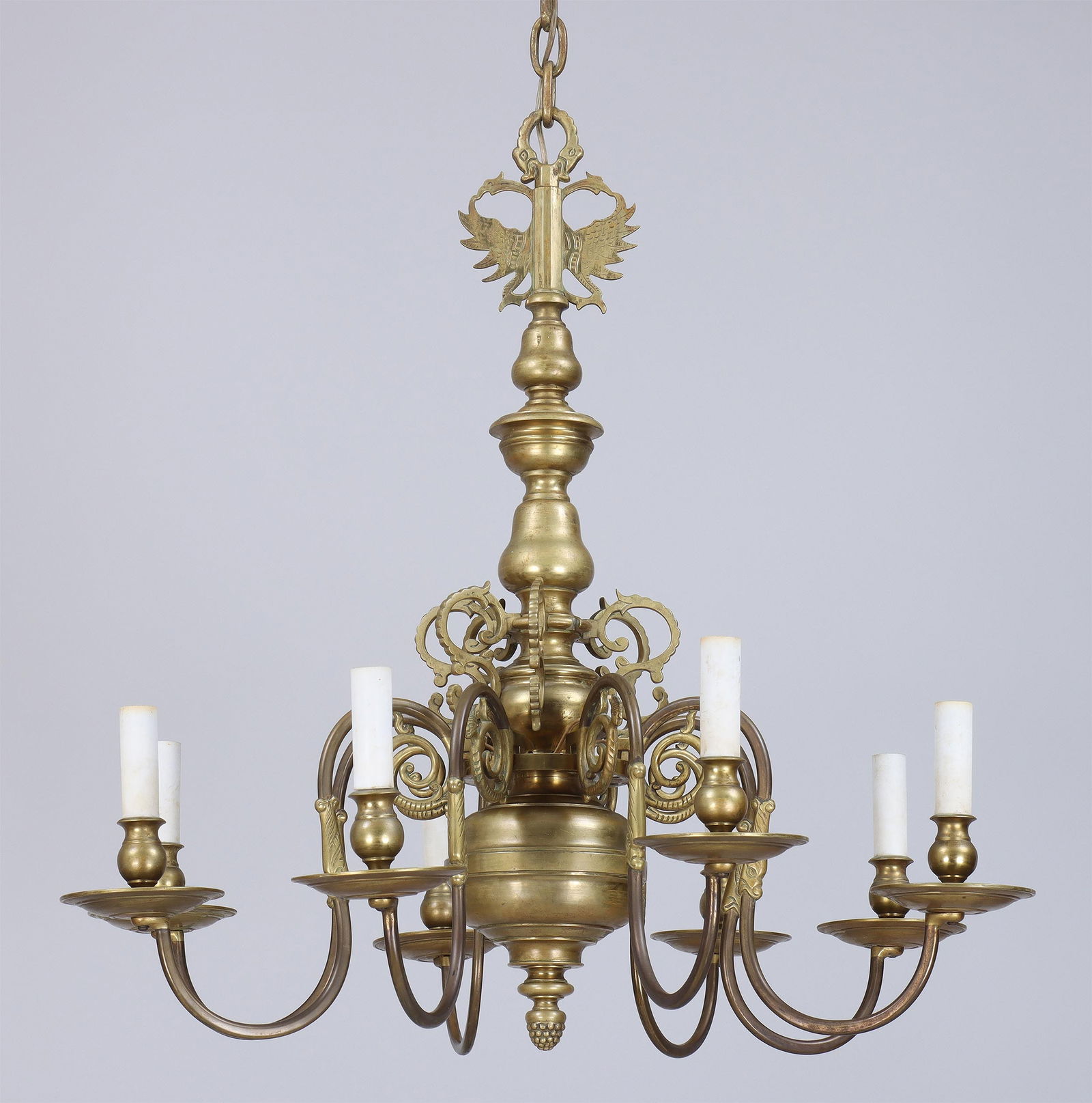 18th/19th Century Brass Eight-Light Chandelier: 18th/19th Century Brass Eight-Light Chandelierhaving double eagle finial surmounting tiered S-scrolls and scrolled candlearms issuing from a baluster stem, the candlearms with Orientalist male busts a