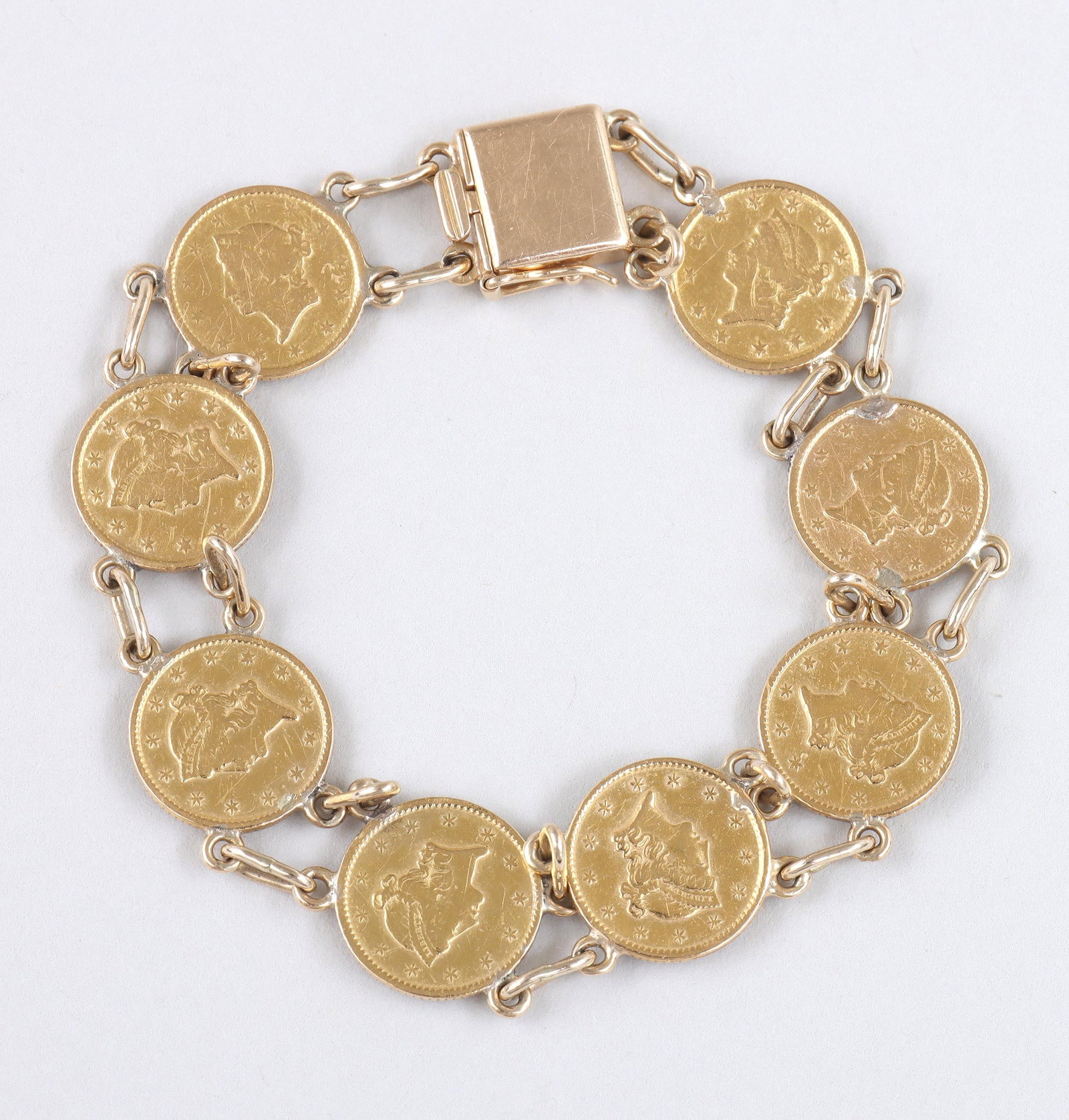 Gold Coin Bracelet: Gold Coin Bracelet having (8) gold Liberty Coronet Head one-dollar coins attached with 10k gold chain links, dates on coins comprising 1849, 1851, (3) 1852, and (3) 1853, some coins with New Orleans �